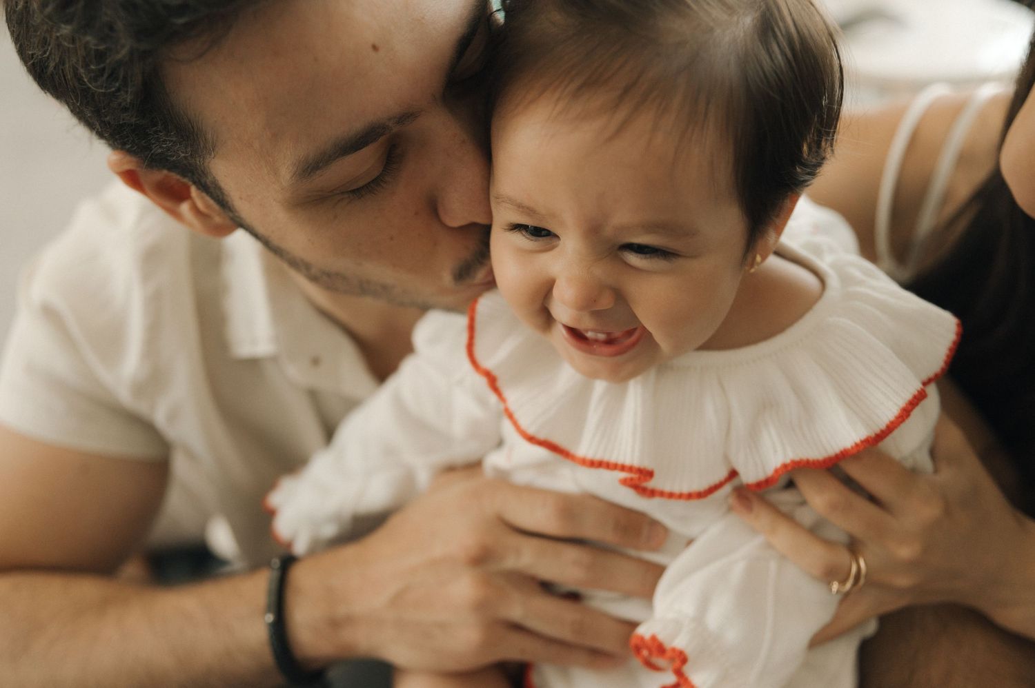 A collage of tender family moments captured in soft, warm tones showing parents interacting with their young child.