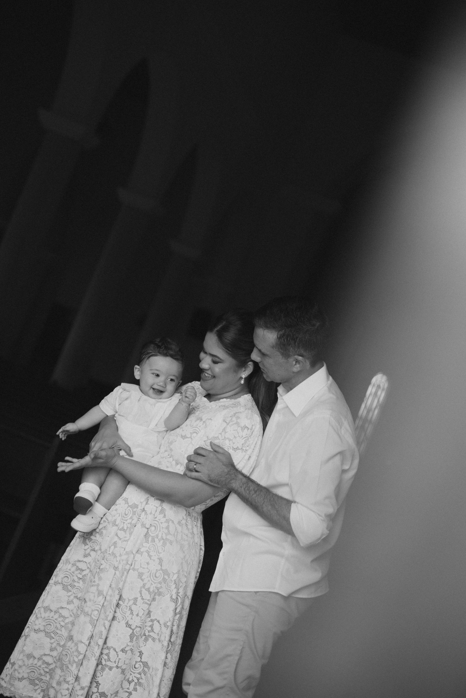 A series of black and white photos showing people in white clothing dancing together.