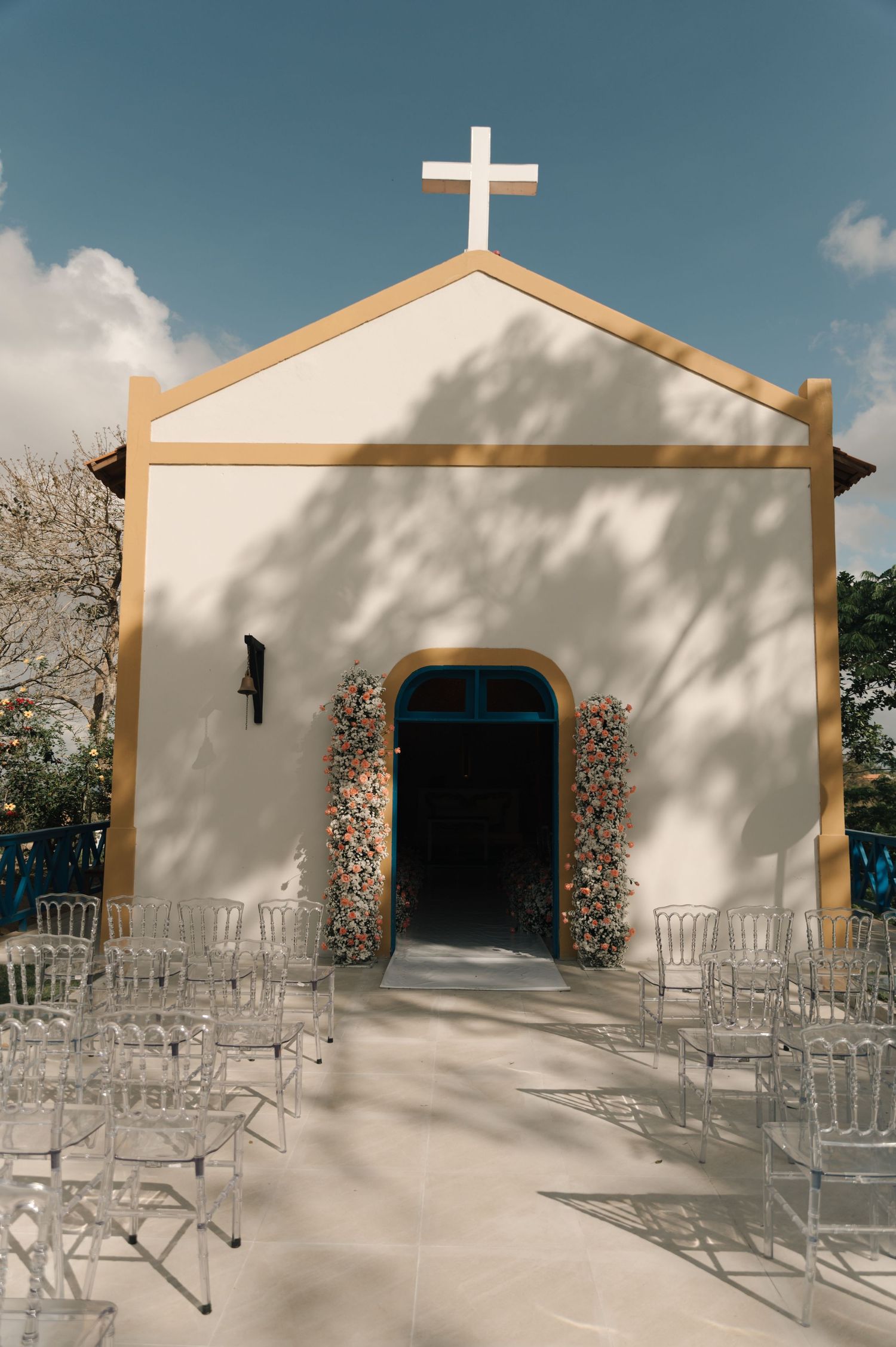 A series of four photos showing a white stucco church exterior with empty metal chairs arranged for an outdoor ceremony.
