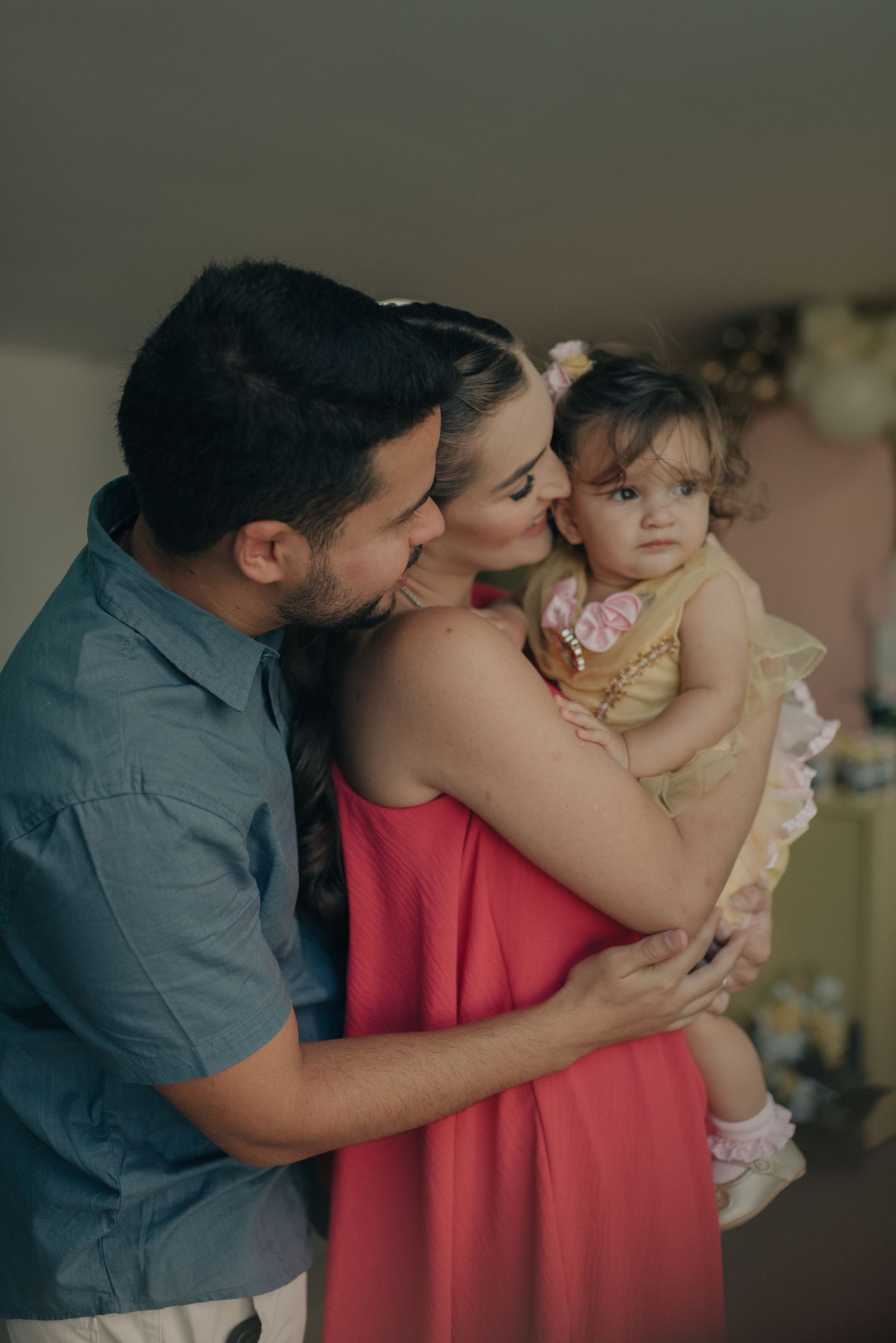 An intimate family moment captured during a celebration with soft lighting.