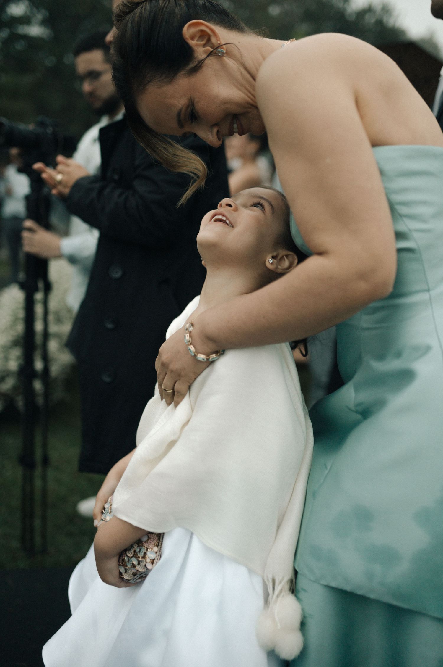 A couple shares an intimate dip dance pose during a wedding celebration in formal attire.