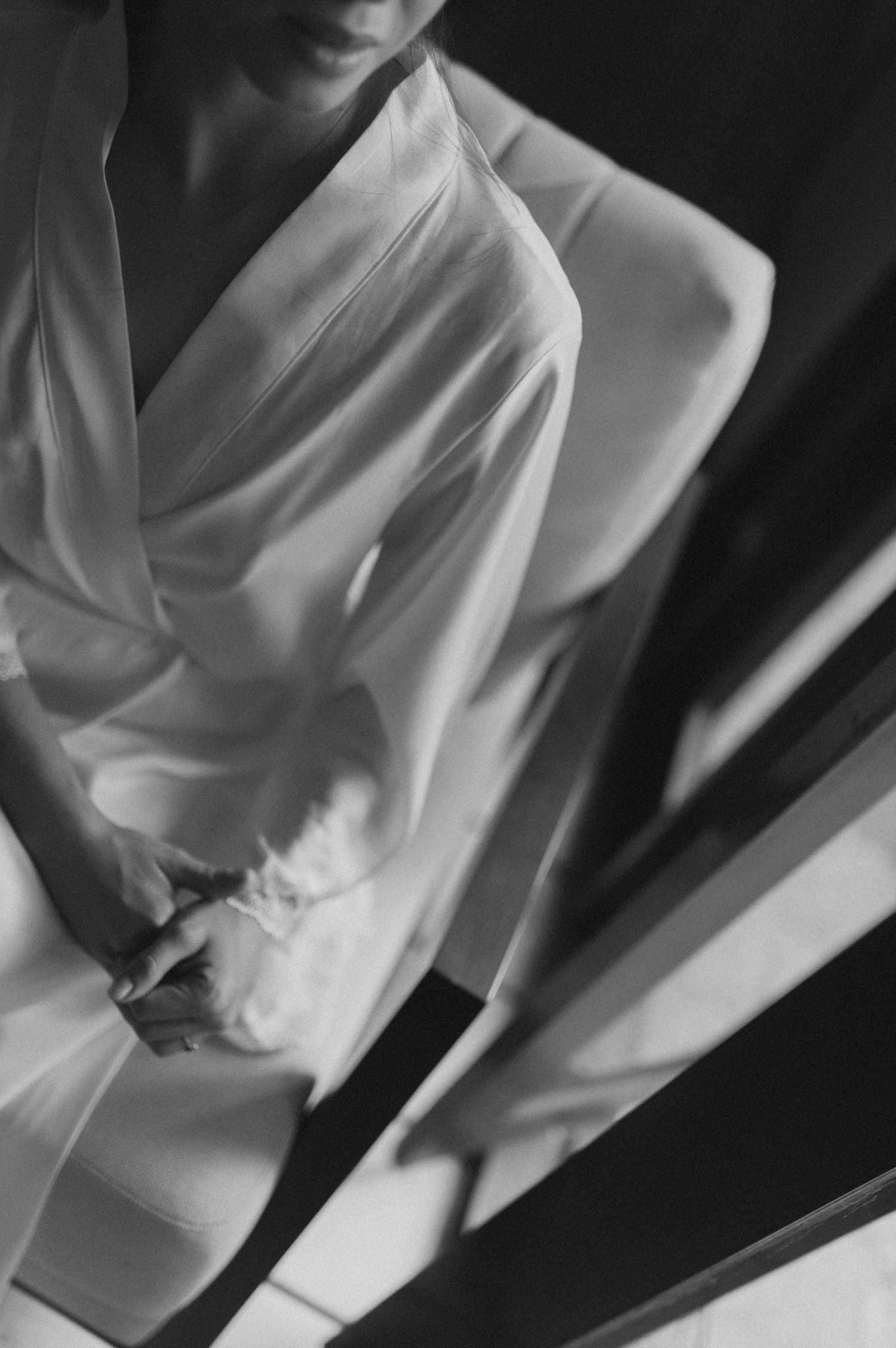 Artistic black and white close-up of flowing white fabric and shadows.