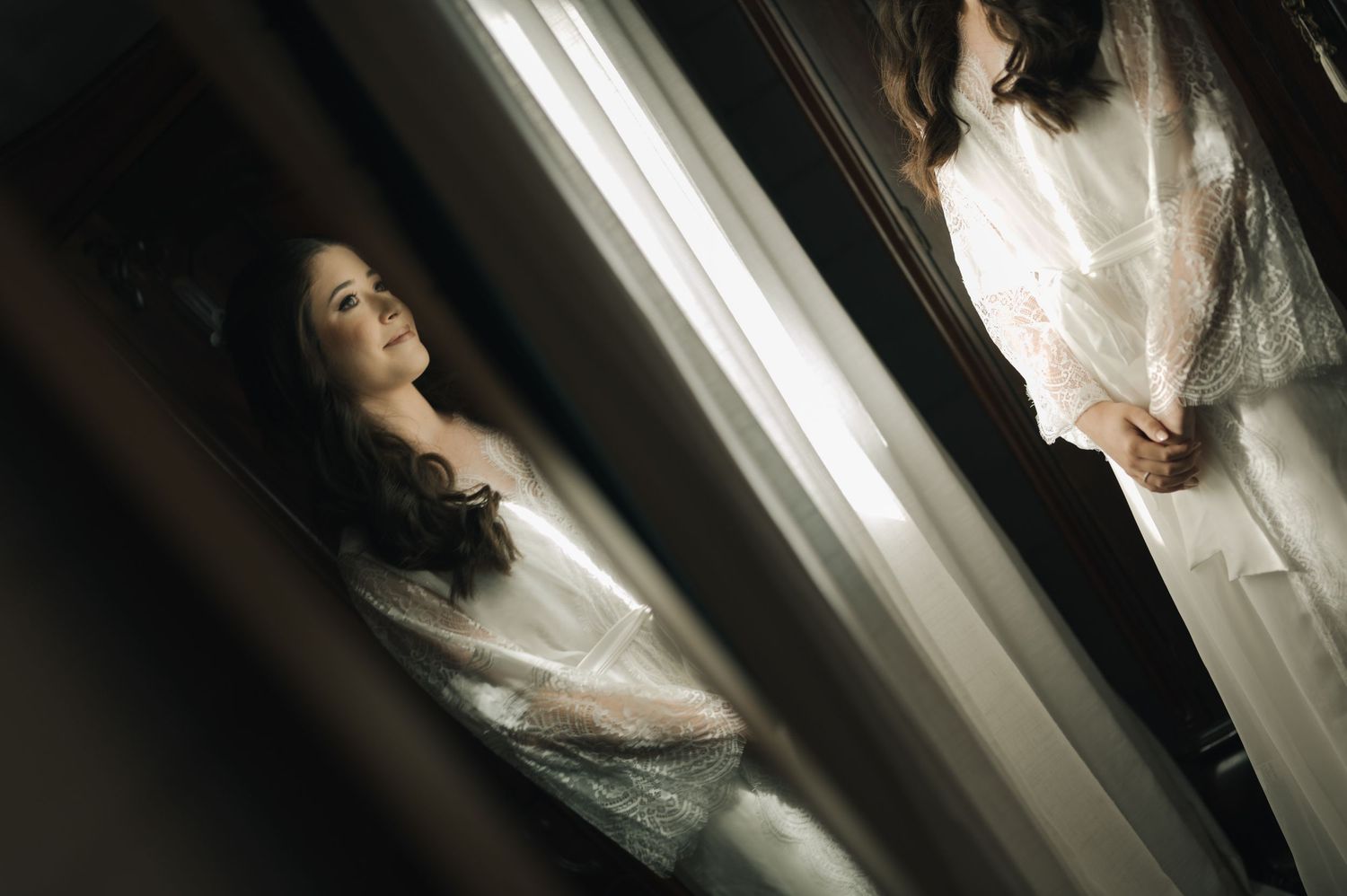 An artistic mirror reflection shot in a softly lit interior space.