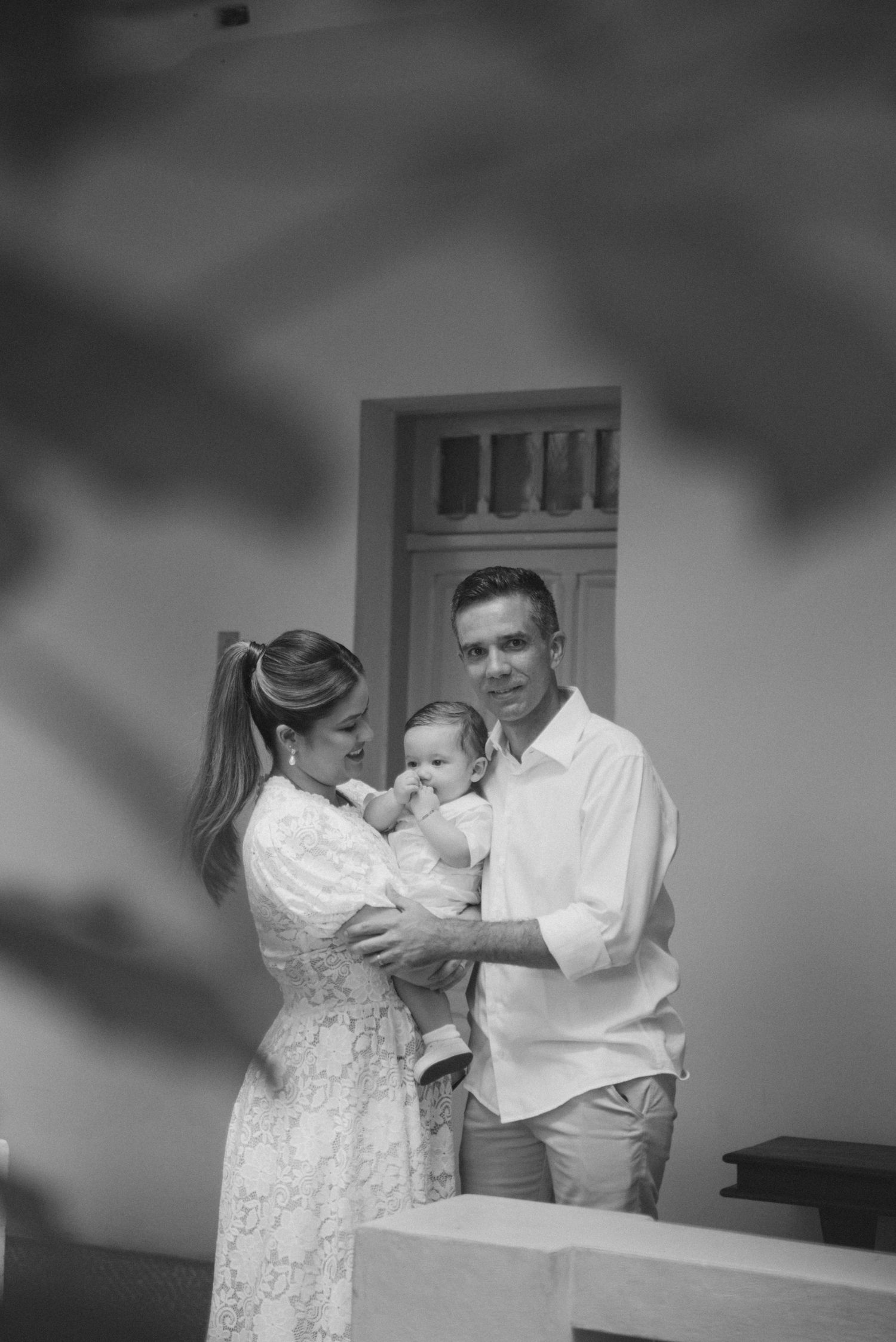 A couple in wedding attire share a tender dance moment in black and white photography.