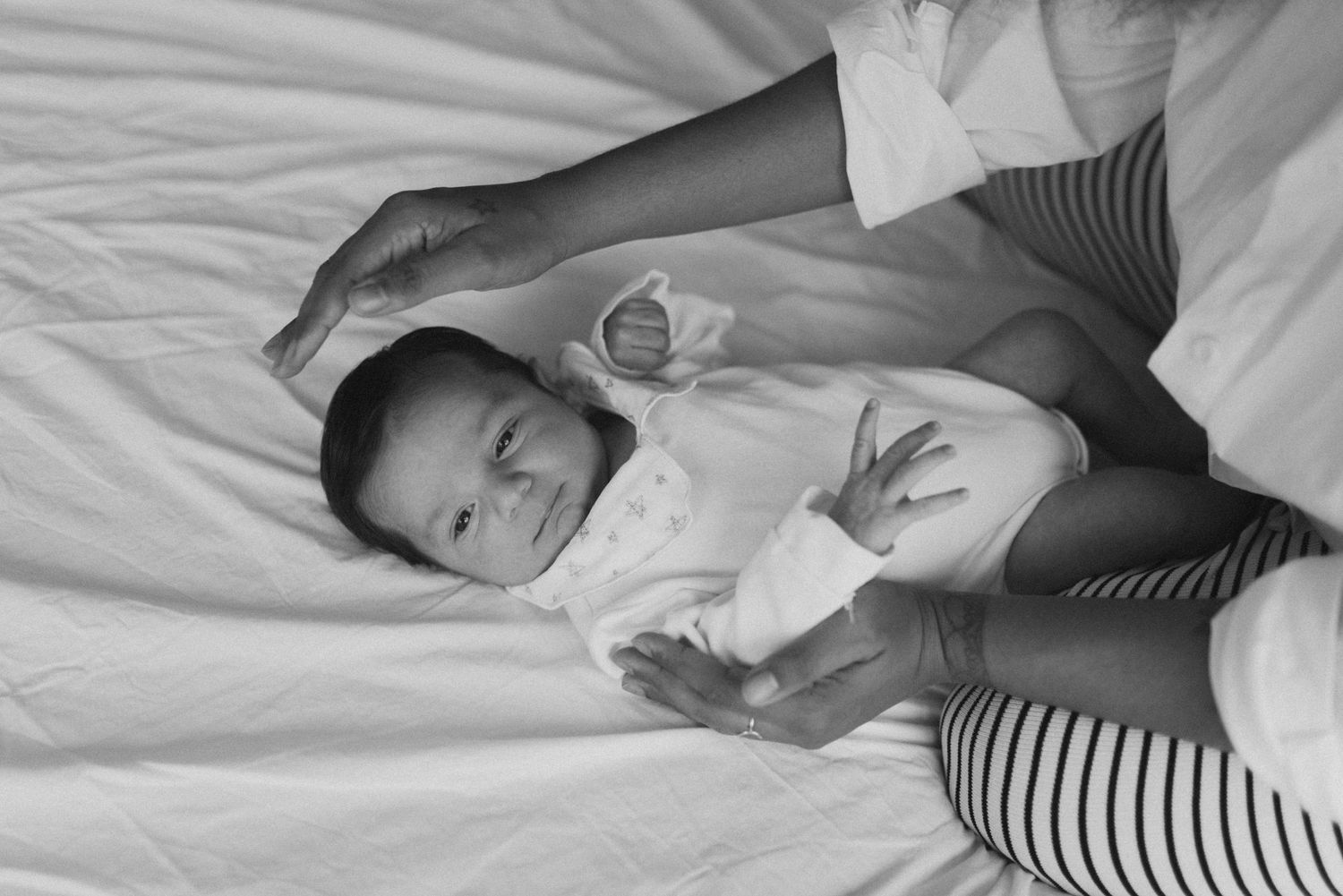 A sequence of photos showing a person sleeping peacefully in white bedding while wearing a striped shirt.