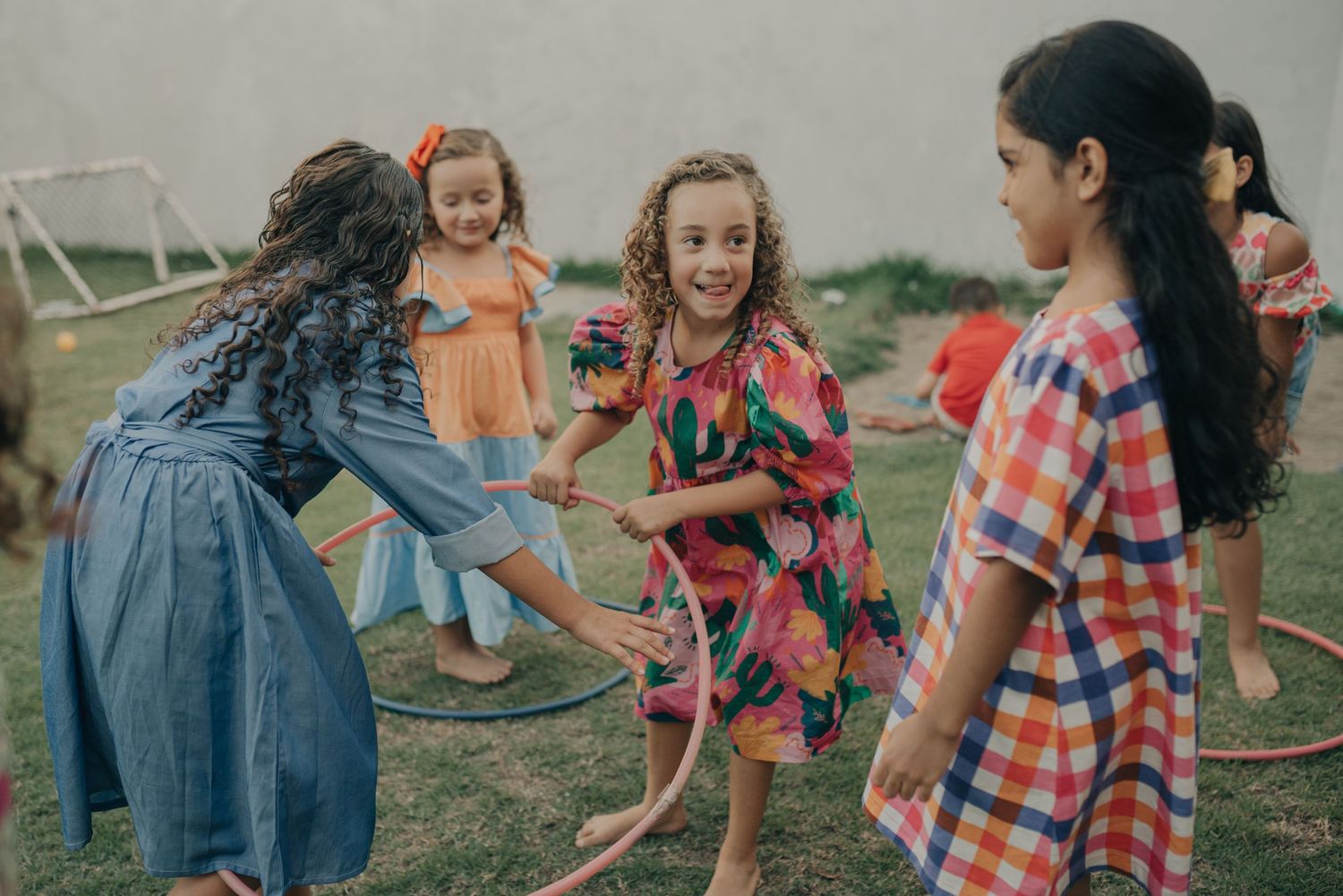 Children playing a fun outdoor game together with colorful clothing and joyful expressions.