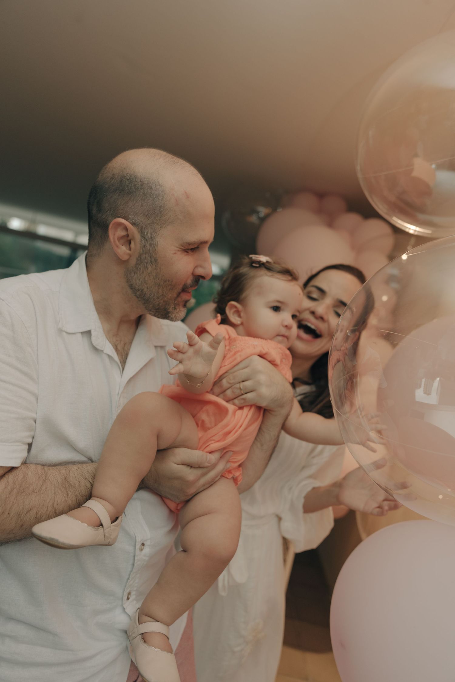 A joyful family moment with balloons during a celebration.