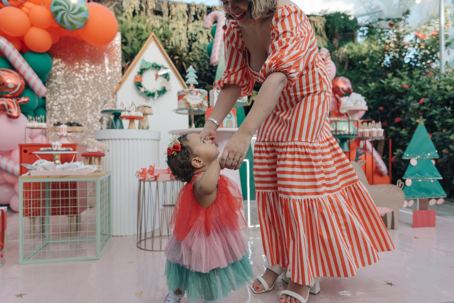 A festive celebration scene with orange and mint green decor featuring a striped dress and tulle party outfit.