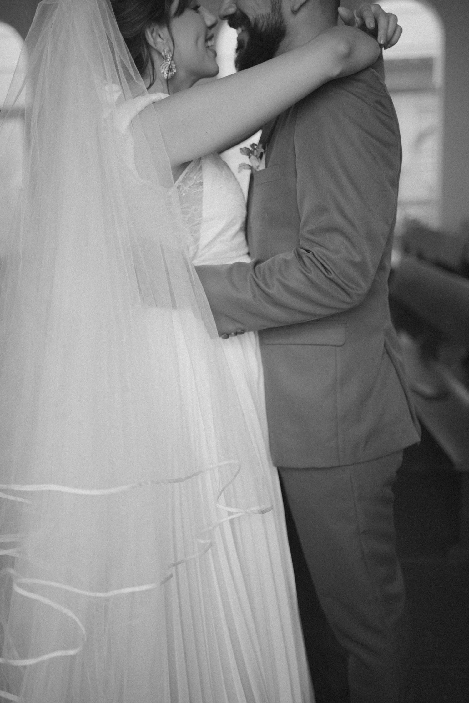 Black and white photo of newlyweds sharing intimate dance moment.