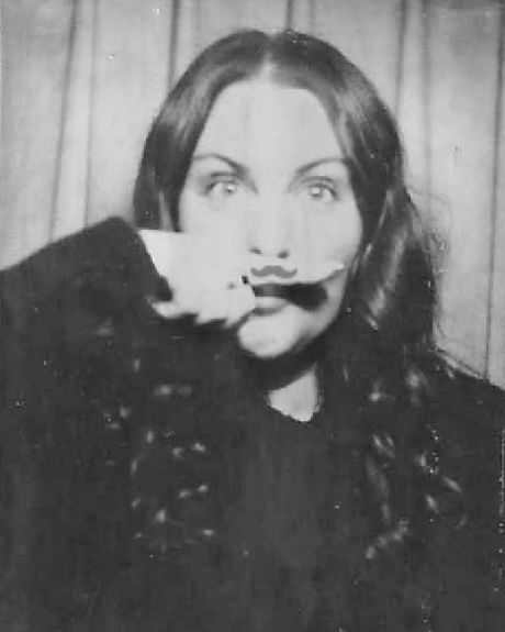 A playful black and white portrait showing Danielle Conner - Northern California wedding photographer's personality with a silly face.