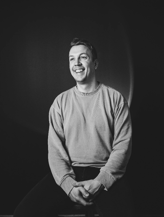 Black and white portrait series showing joyful expressions in dramatic lighting.