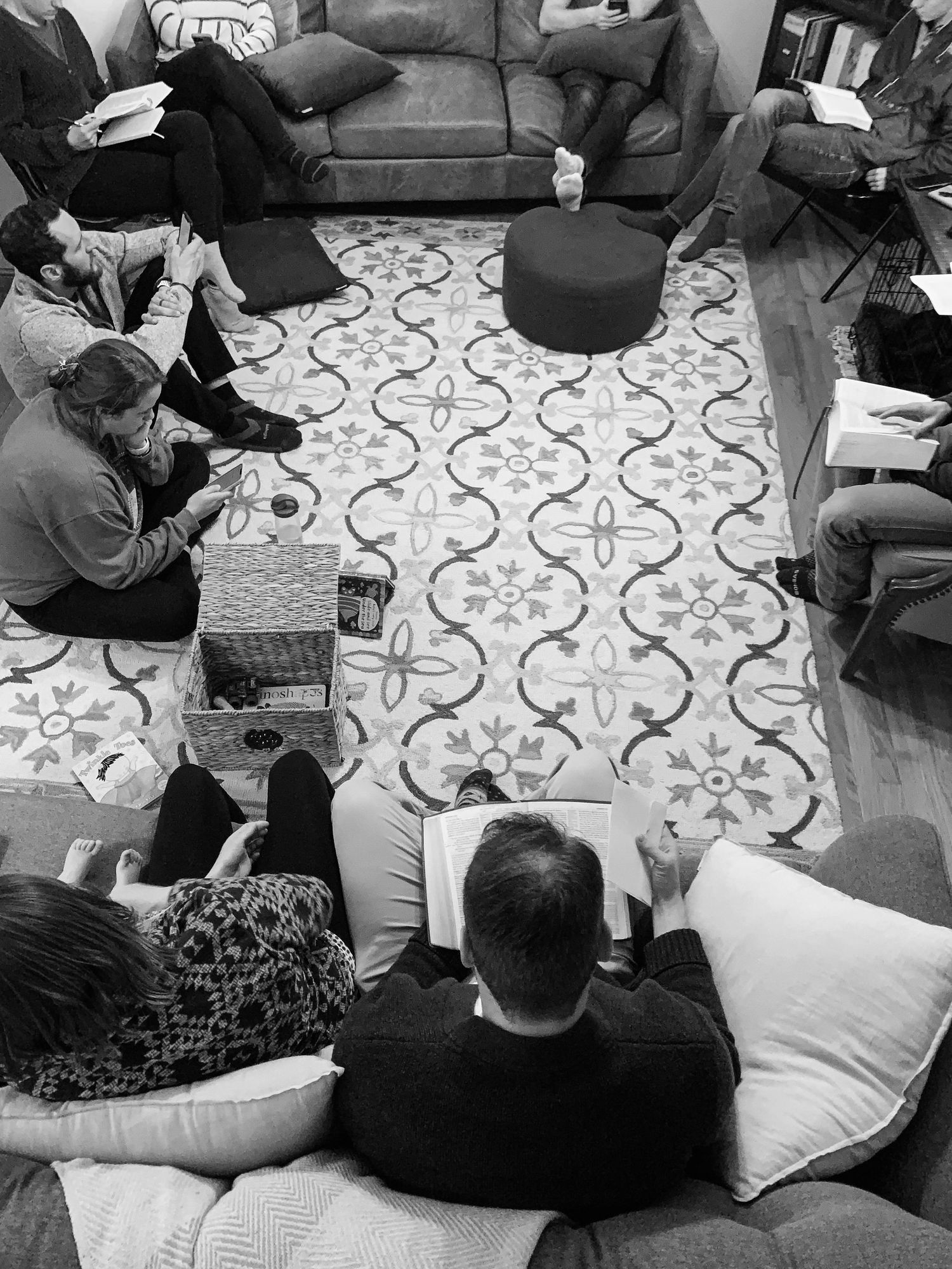 overhead shot showing a group of church members sitting around a living room in a home during community group in Fairmont, WV