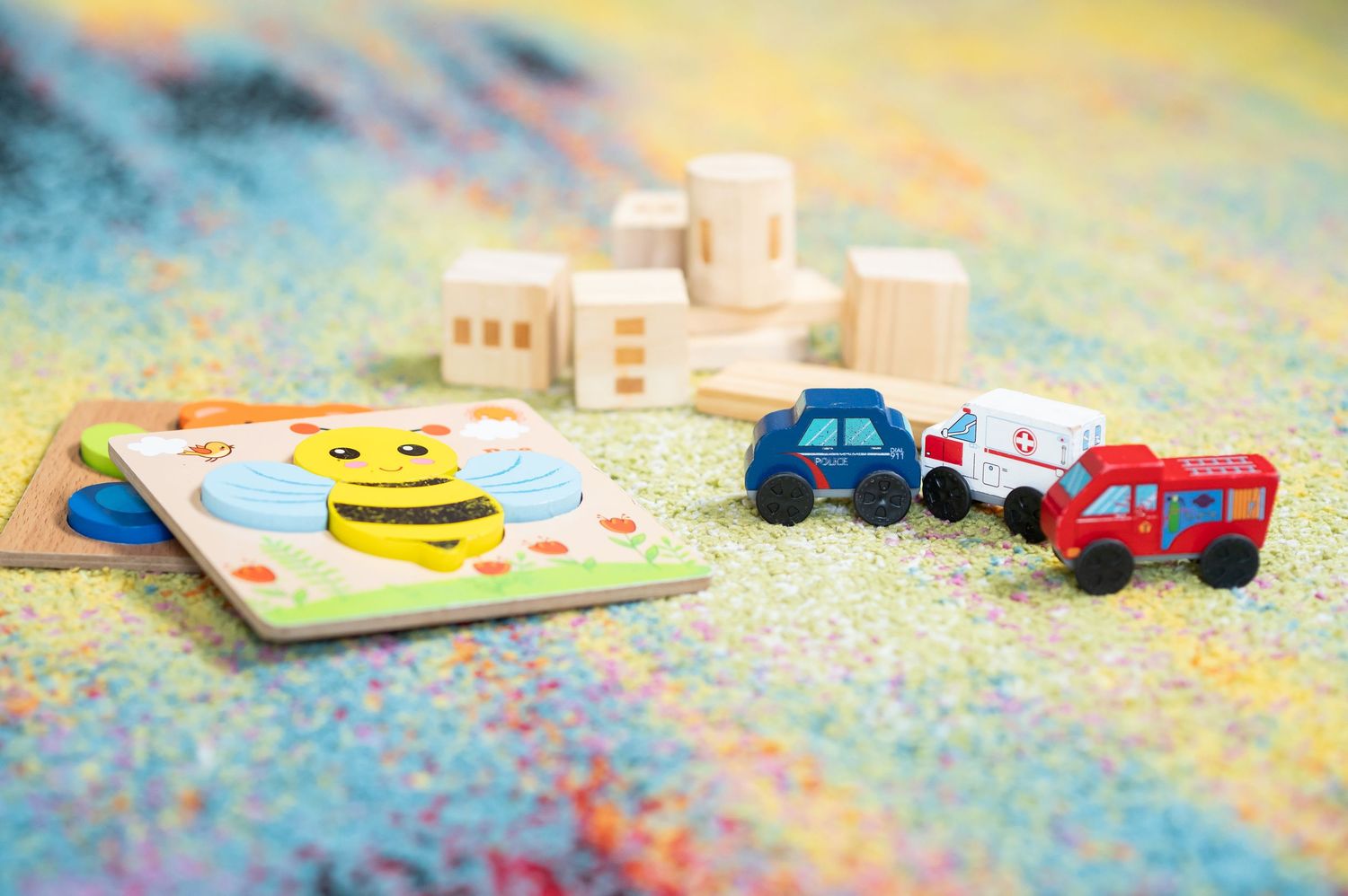closeup of wooden baby toys scattered on a rug in  the toddler room at Crossroads Church in Morgantown, WV