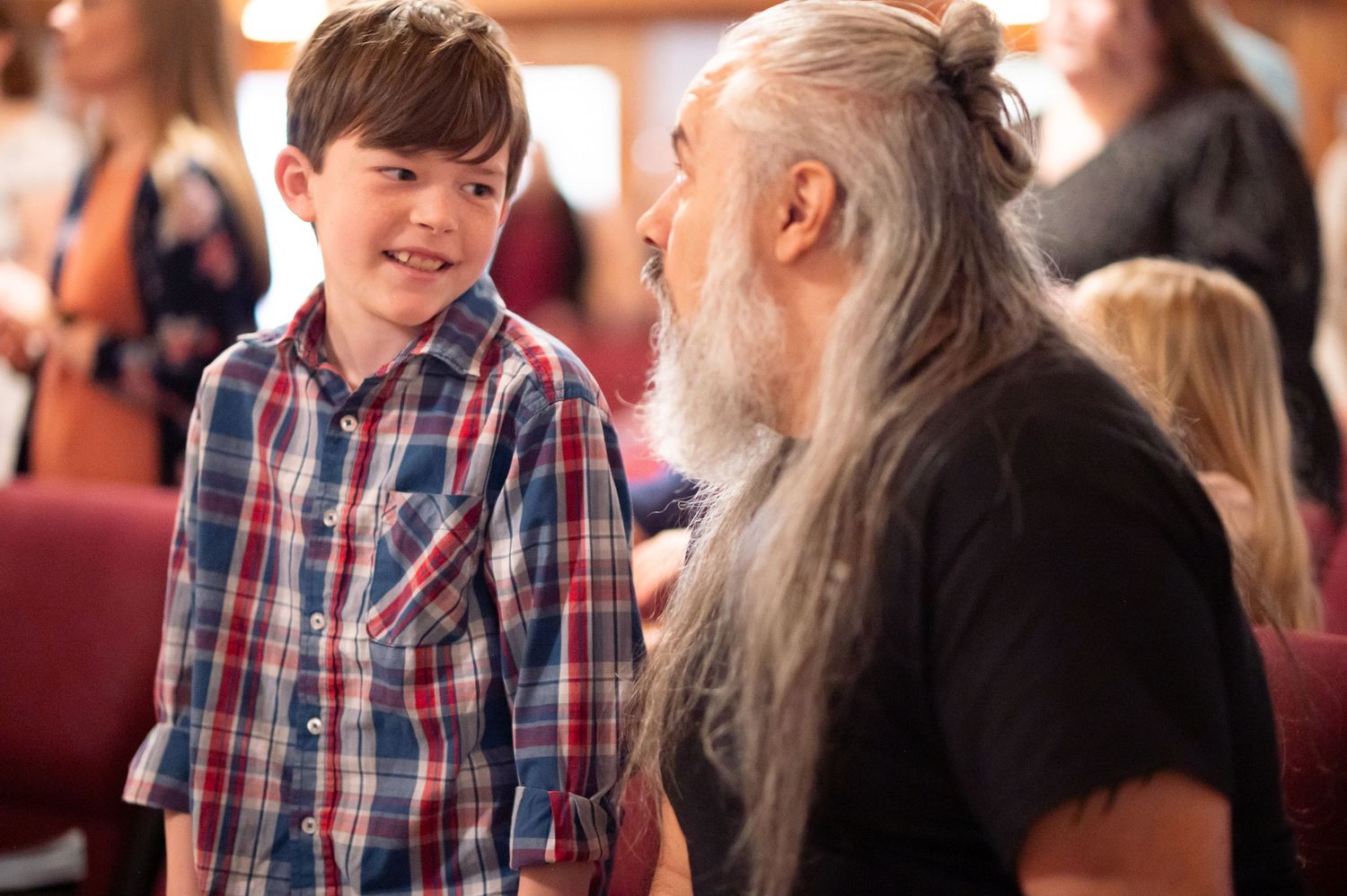 Pastor Chatto jokes and laughs with a young church attendee during worship at a Crossroads Morgantown church service in downtown Morgantown