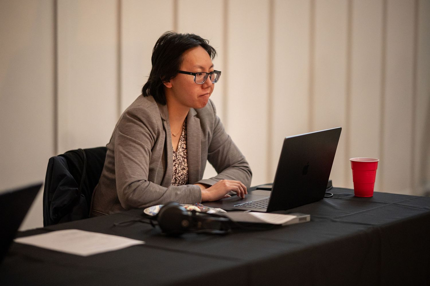 A Crossroads member runs sound from her laptop during an event