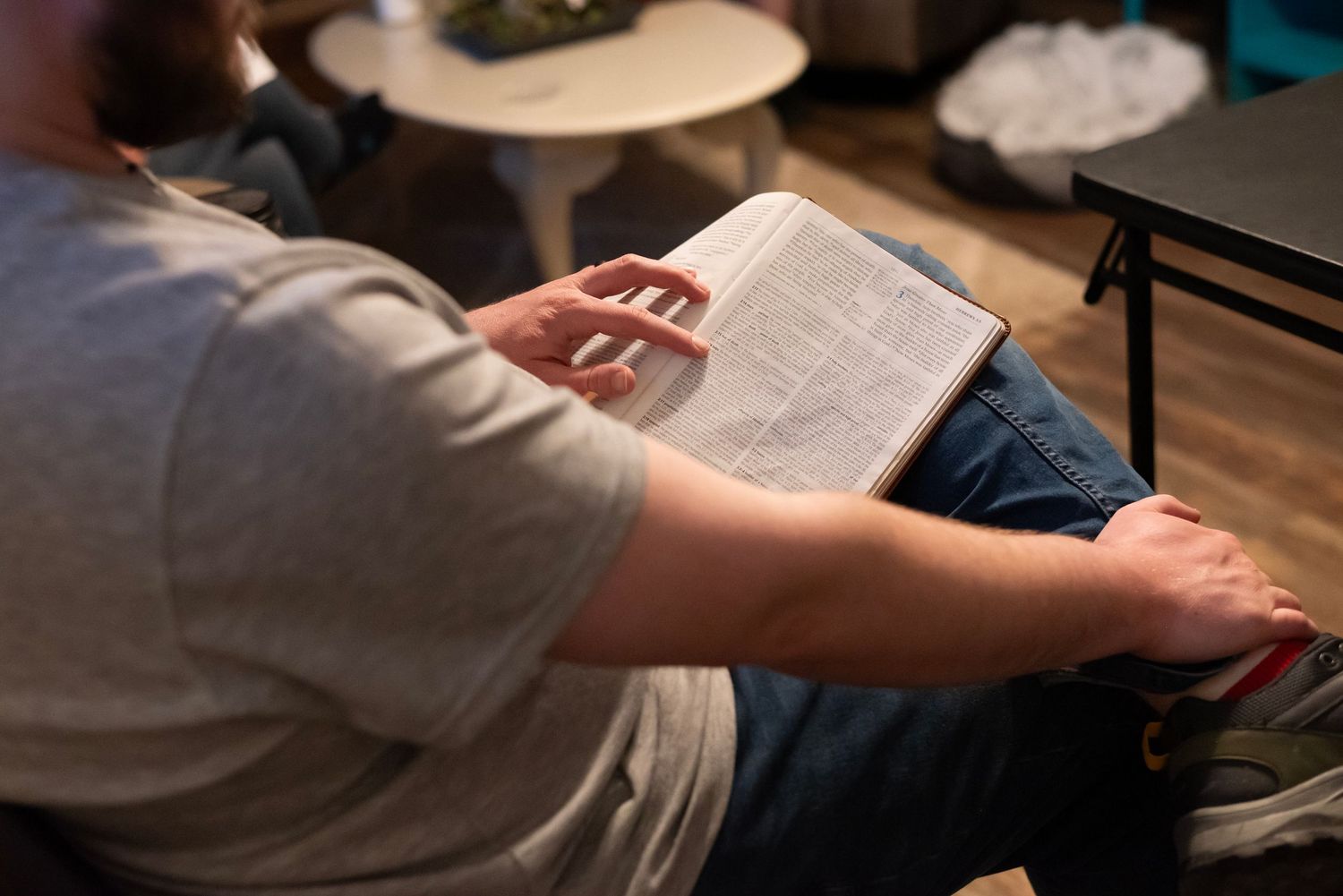 closeup of a man's hands holding and ESV bible during a Crossroads Fairmont community group get together in Whitehall, WV