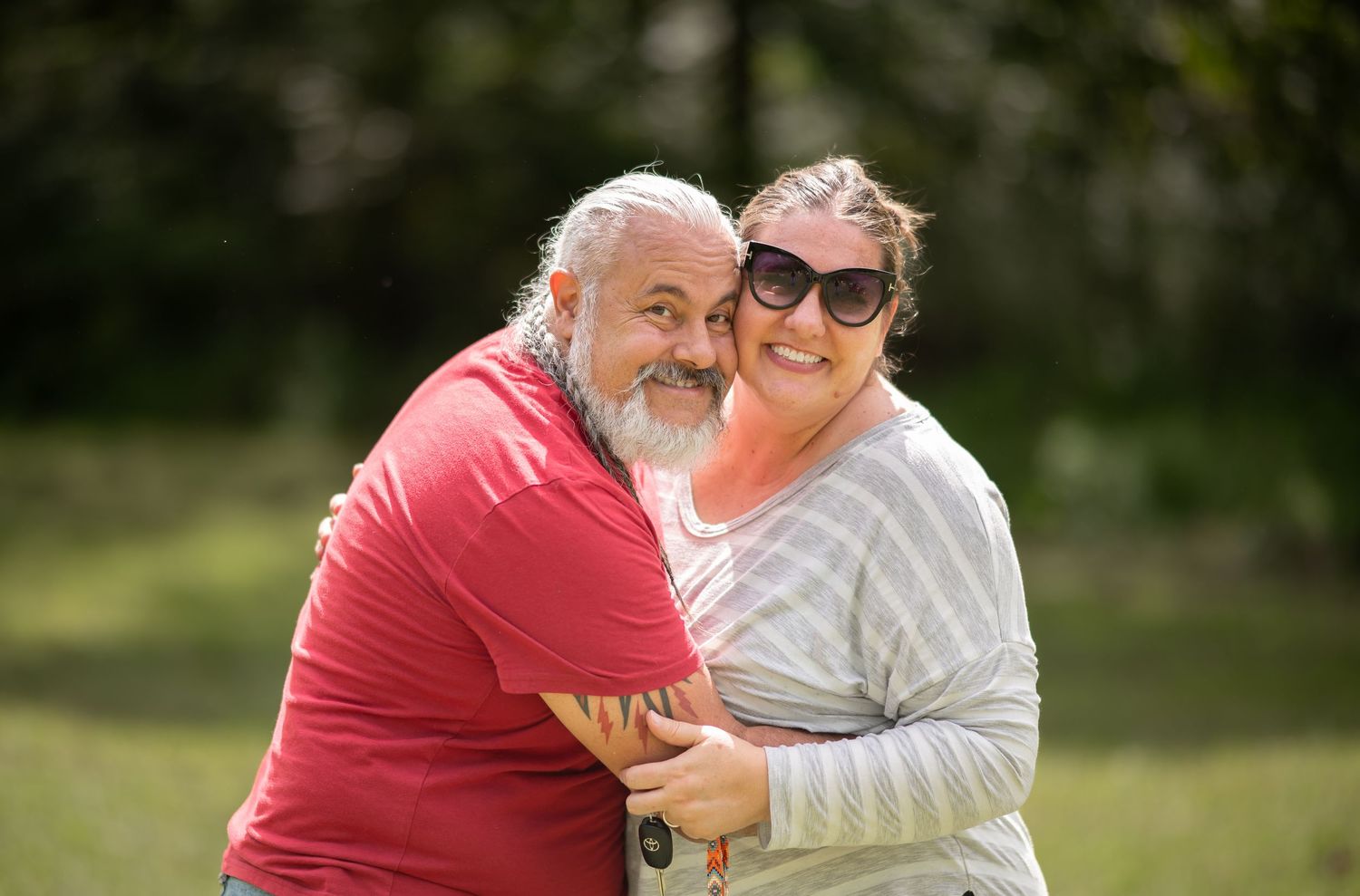 Pastor Chatto and his wife Amanda hug and smile for a picture after an outdoor Sunday morning church service in Morgantown WV