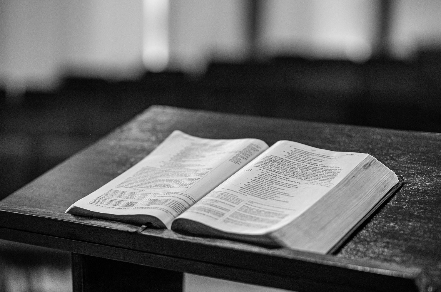 an open Bible lies on a wood pulpit in the auditorium of Crossroads Morgantown