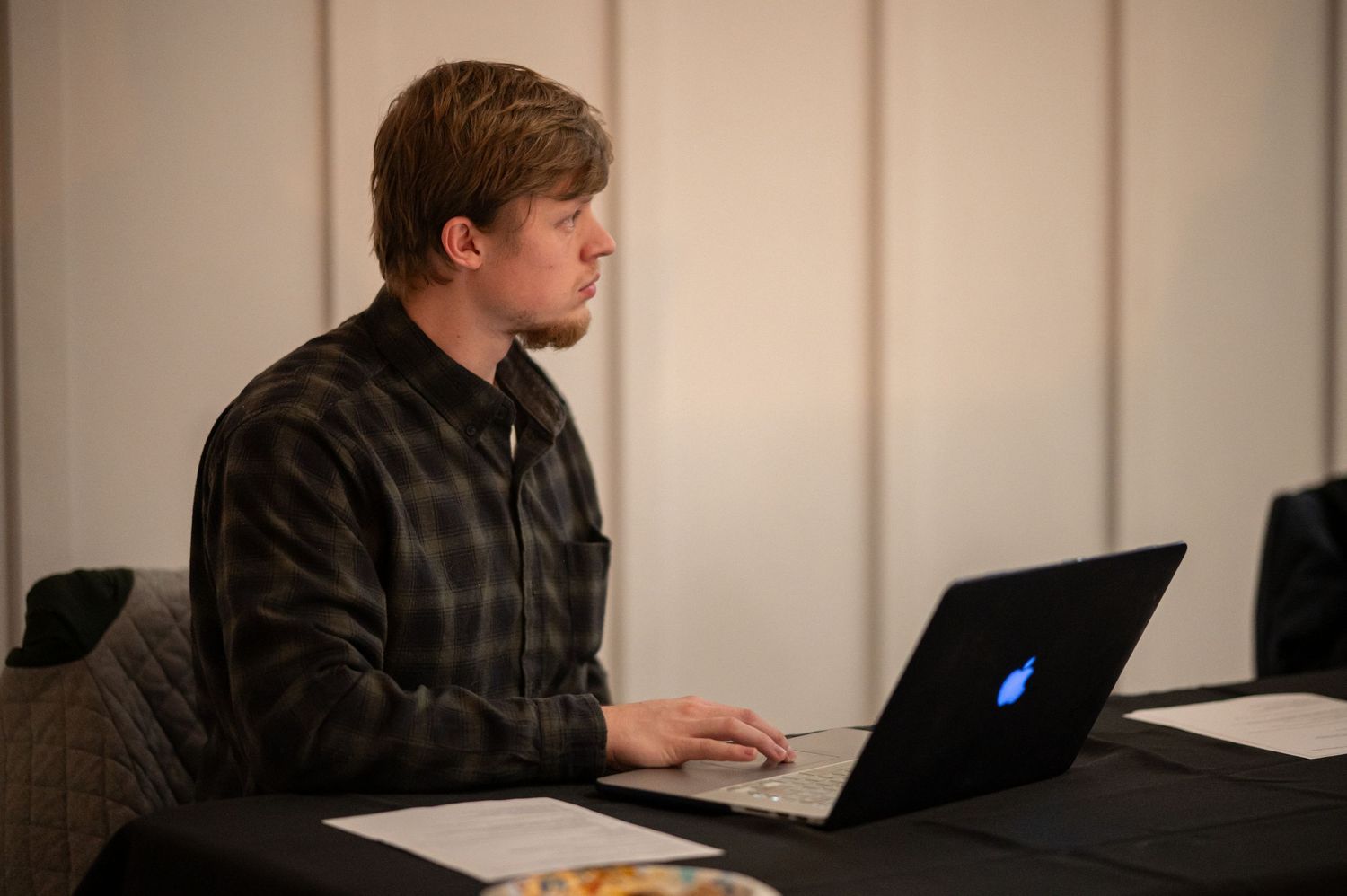 a member of the tech team runs sound from his laptop during a church event