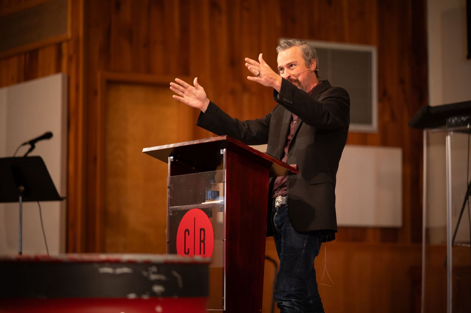 Pastor Chris preaches from the stage of Crossroads Church during a Sunday morning church service in downtown Morgantown