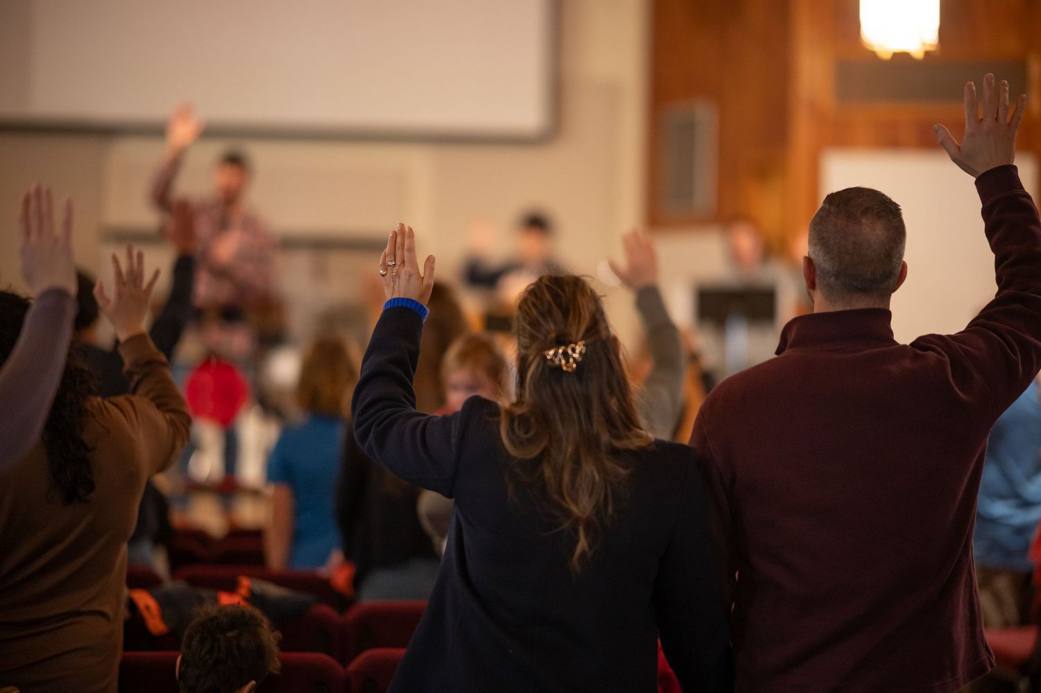 Congregation raising hands in worship during a church service at Crossroads in Morgantown, WV