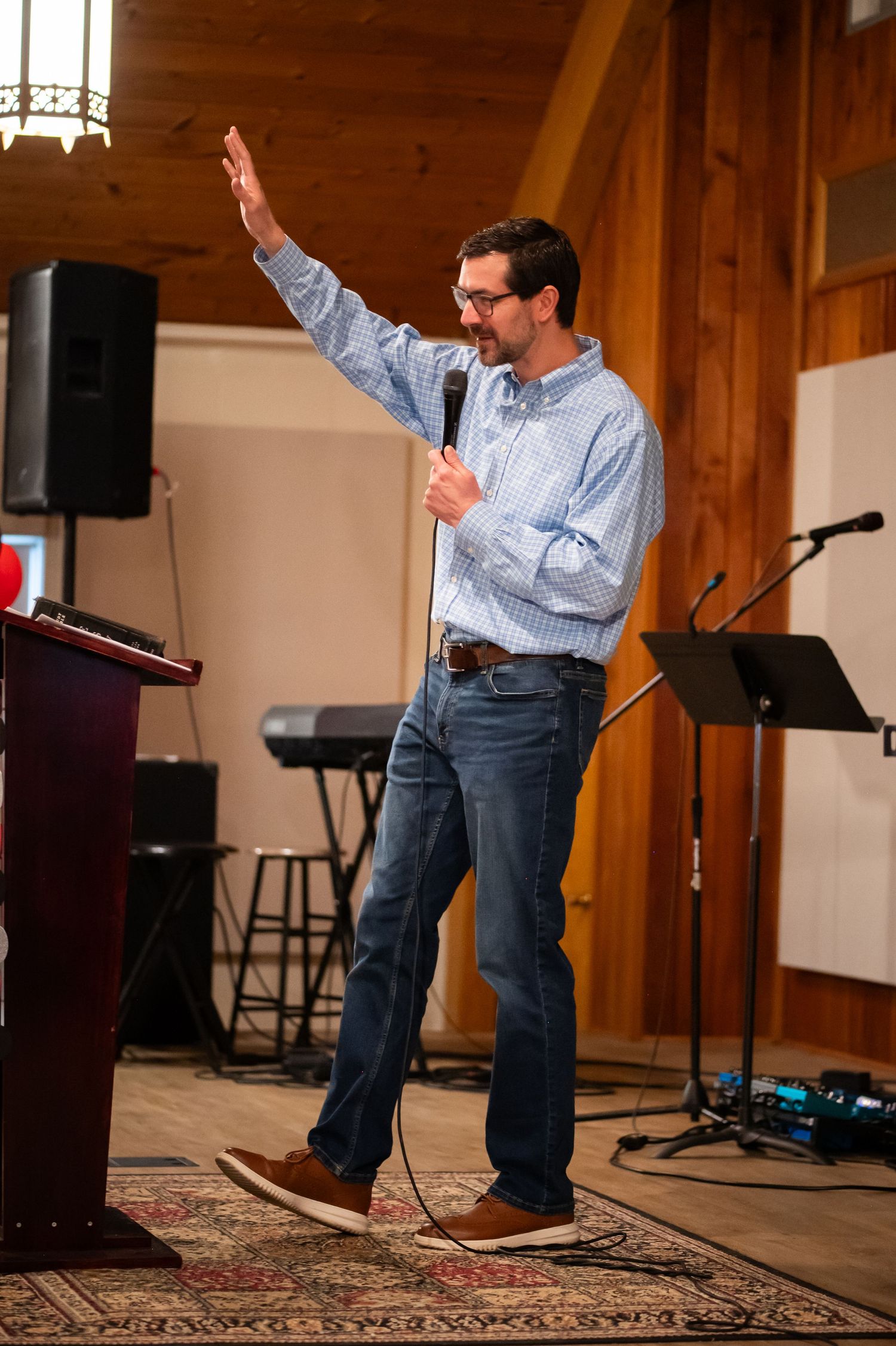 Pastor Scott preaches on stage at the pulpit at Crossroads Morgantown during a Sunday morning church service