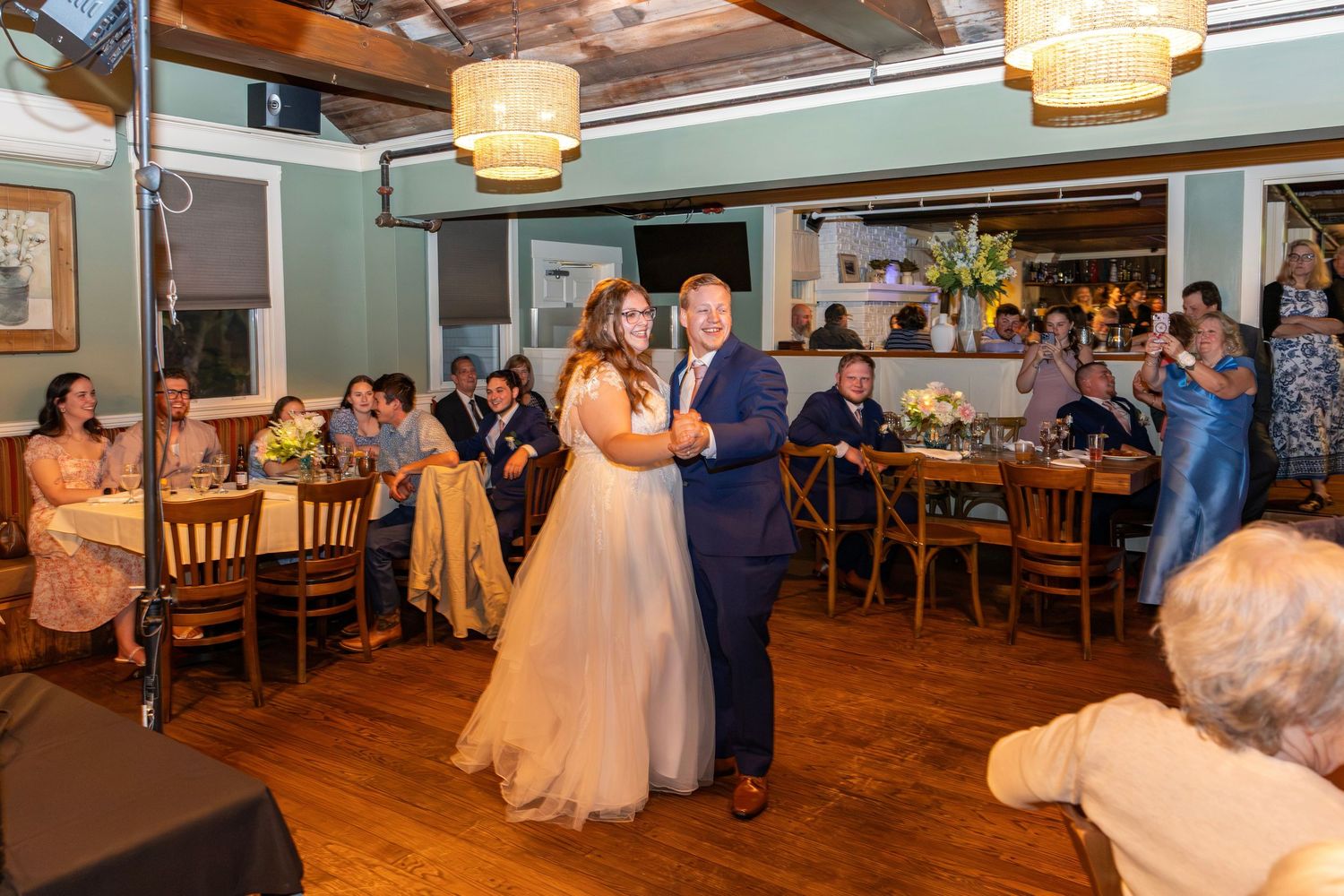 Bride dances with her father during a heartfelt father-daughter dance at wedding reception.
