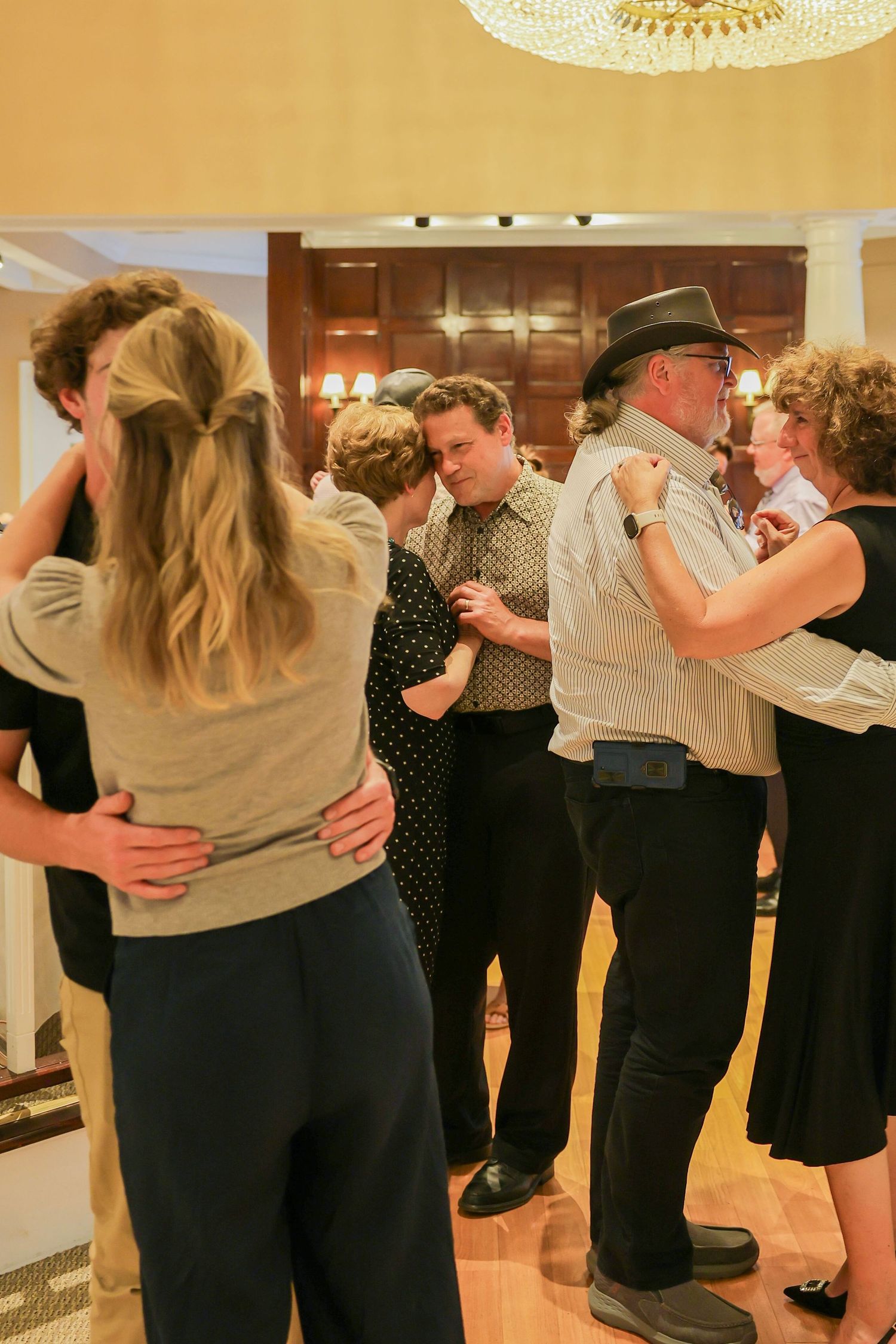 Couples dancing together in elegant ballroom during a festive evening celebration party.