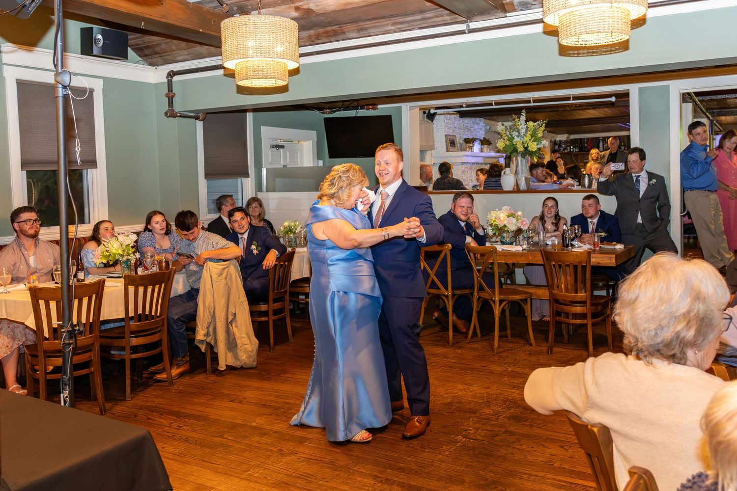 Groom shares a special mother-son dance at elegant wedding reception venue.