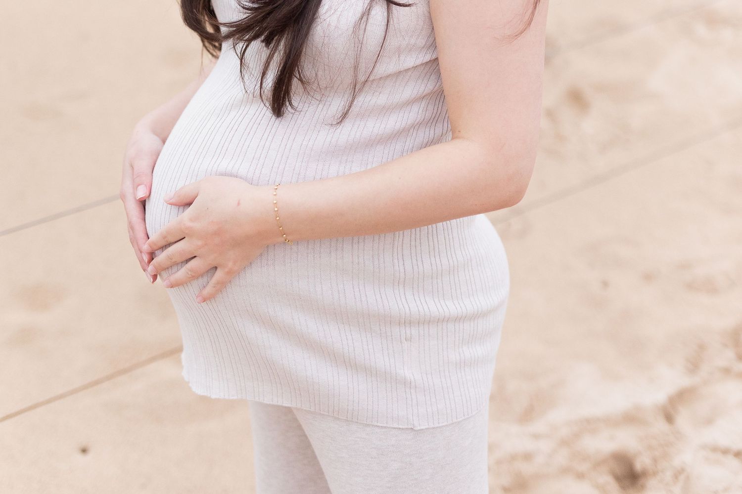 pregnant person at maternity shoot on the beach in sydney