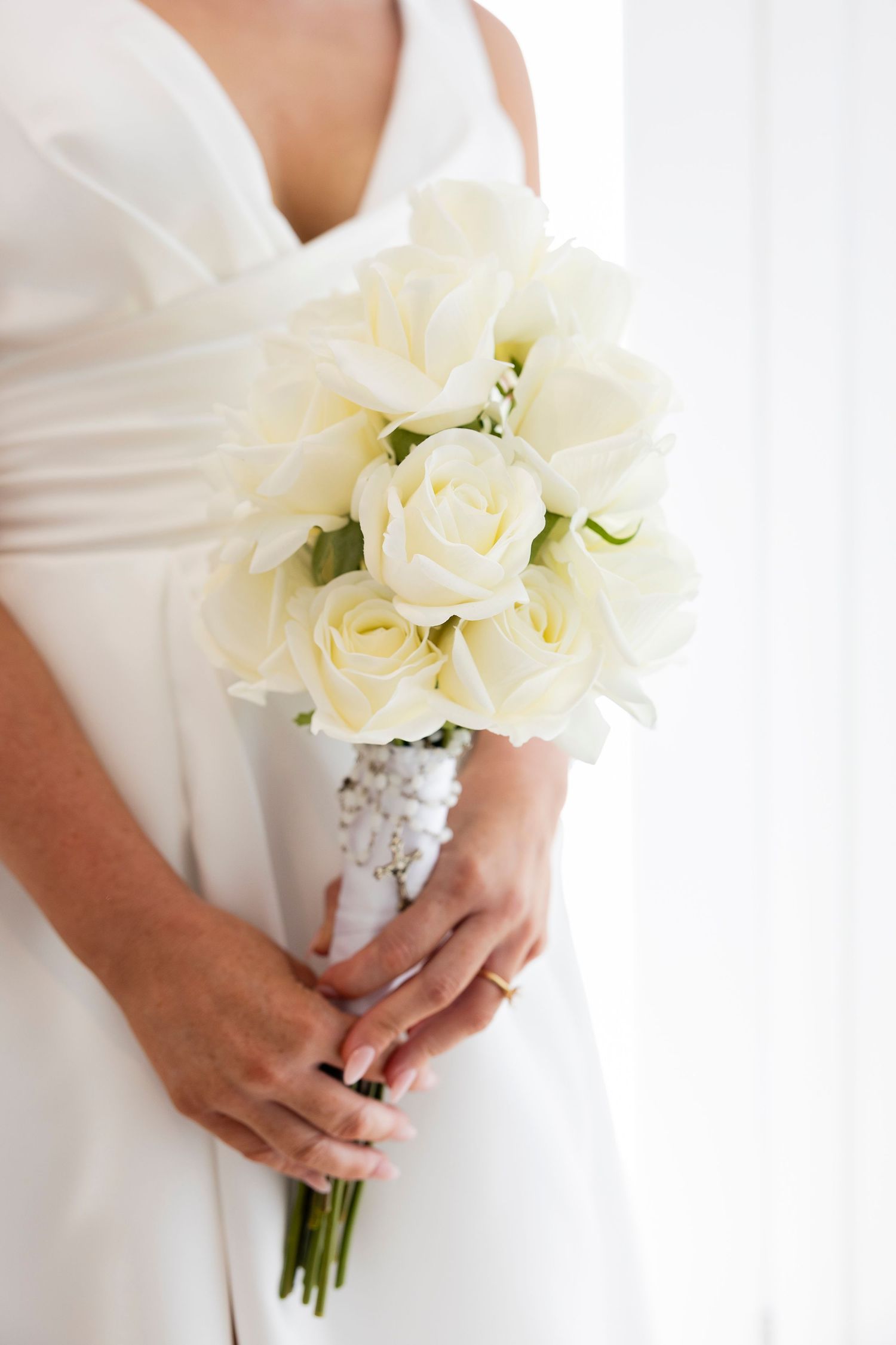 Wedding bride holding her bouquet, candid wedding photo