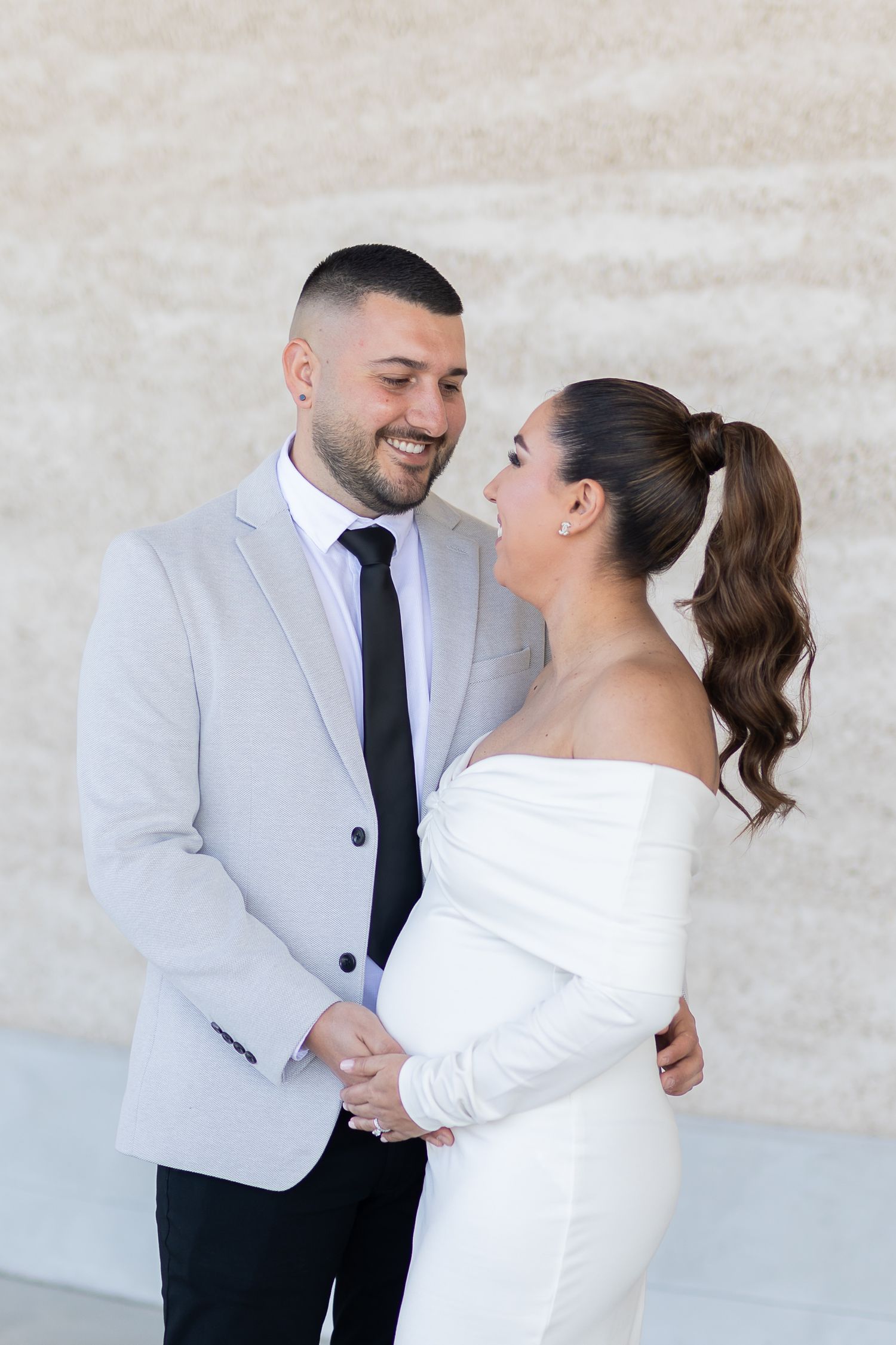 bride and groom touching baby bump in Sydney
