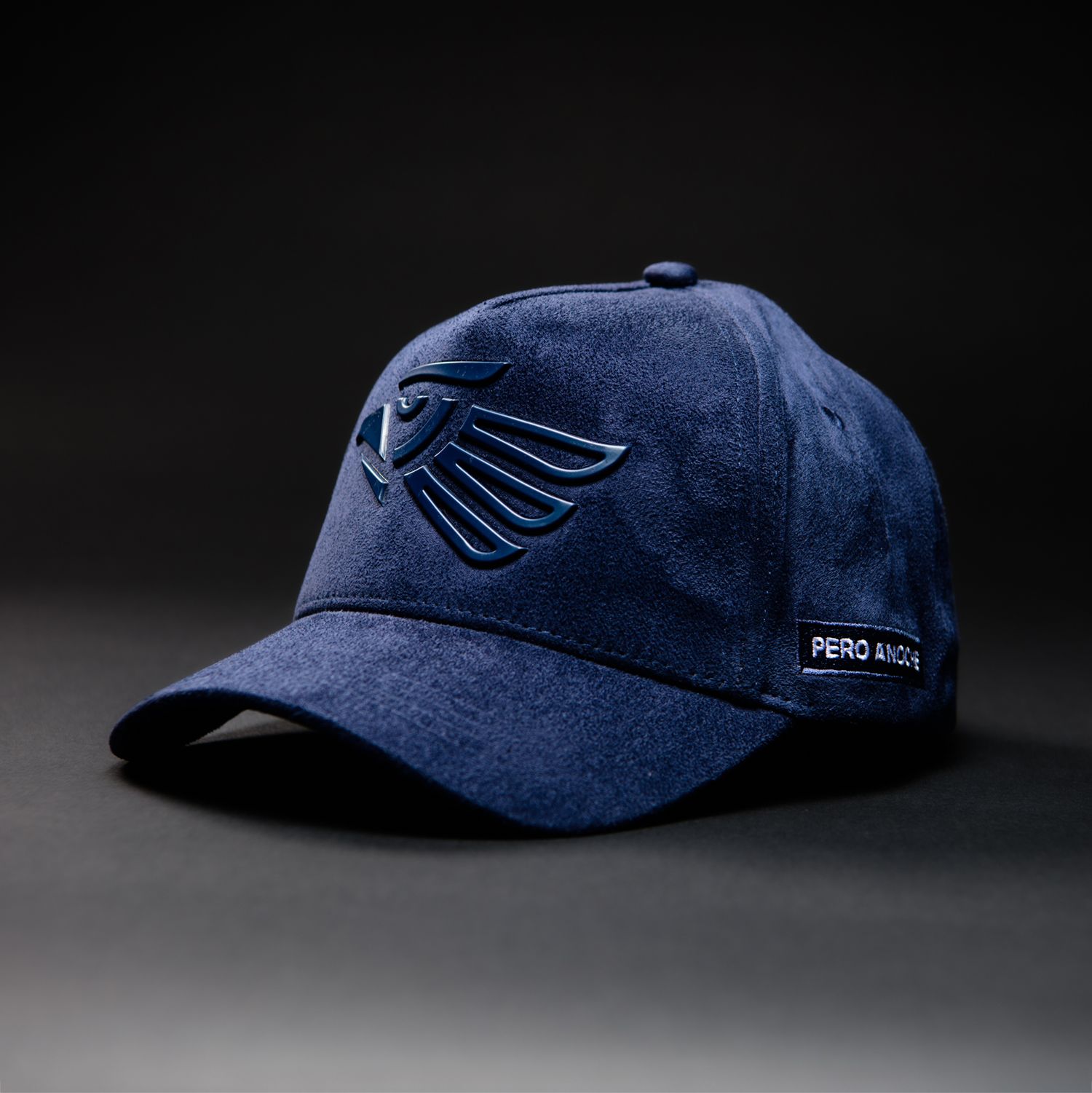 A navy blue baseball cap with embroidered wing logo and Pro Line branding on dark background.
