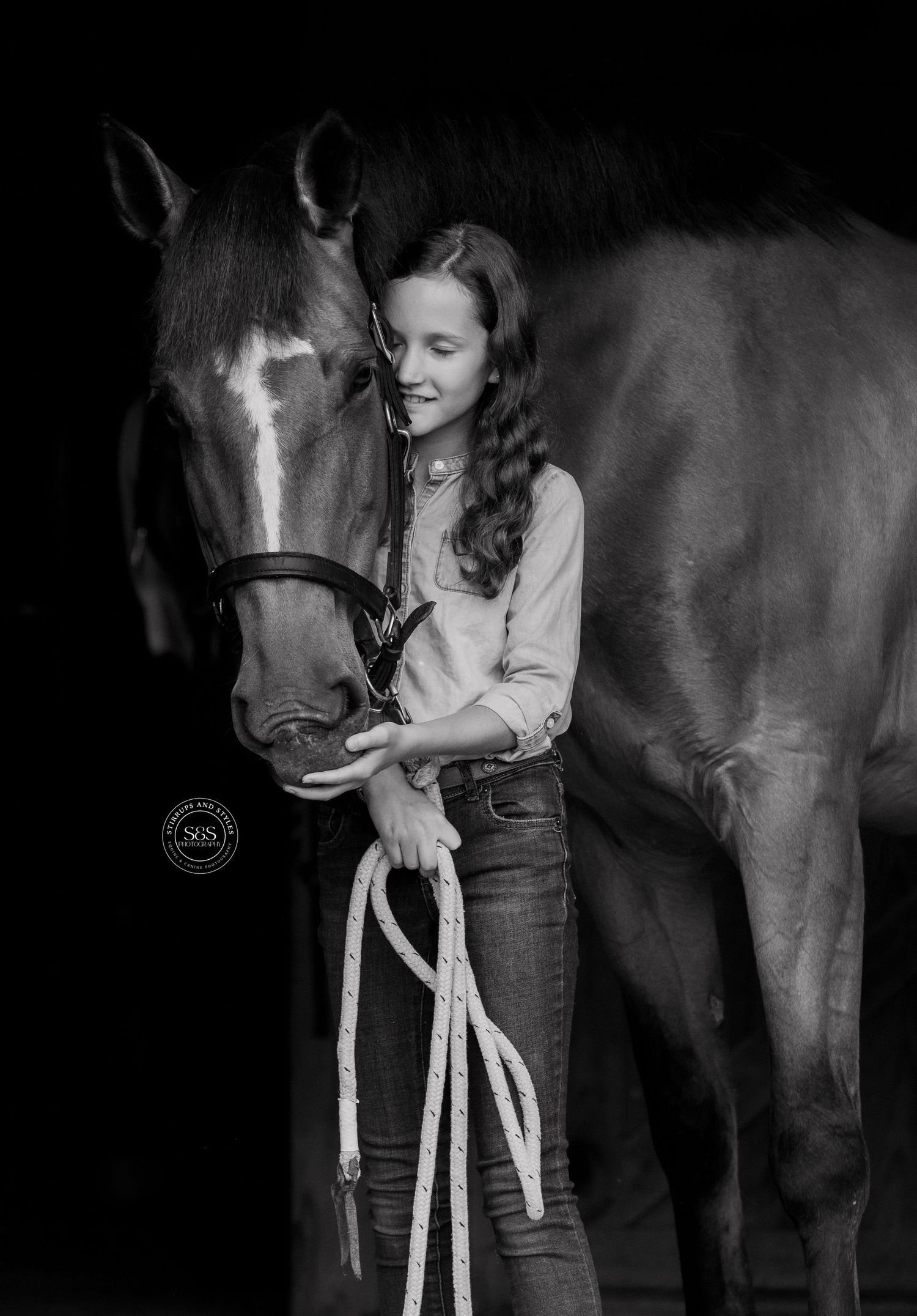 A beautiful horse and companion share a tender moment in dramatic black and white.