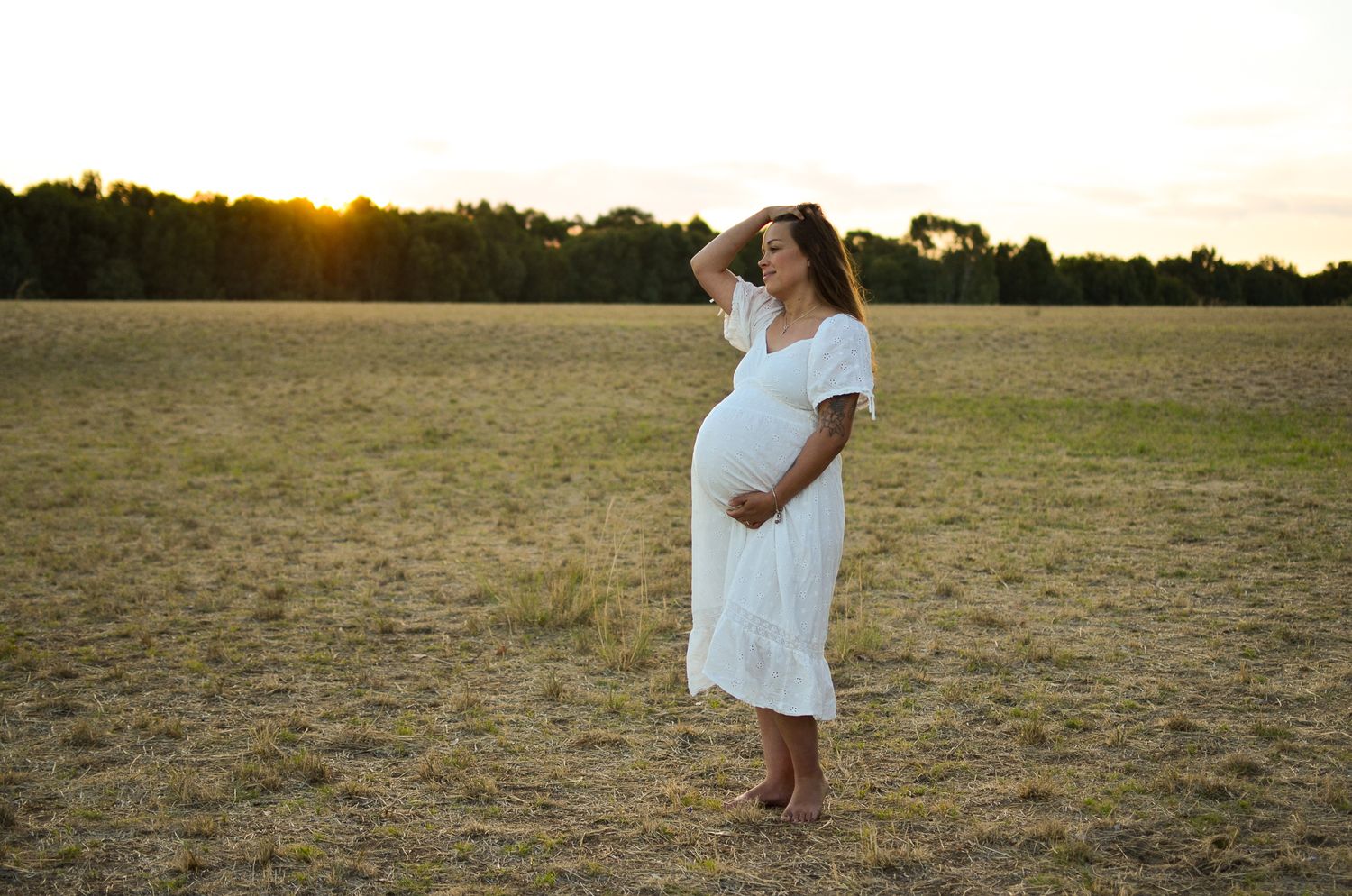 Pregnant mum standing in a paddock at sunset - Perth