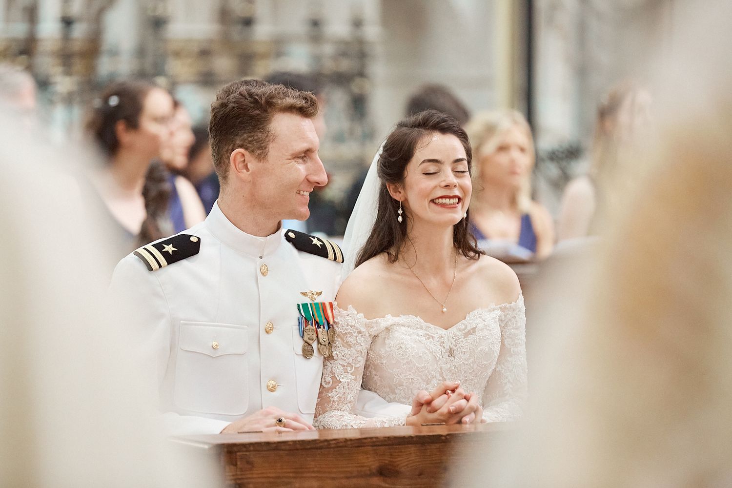 Bride and groom smiling and singing in church. Documentary catholic wedding photography Europe.
