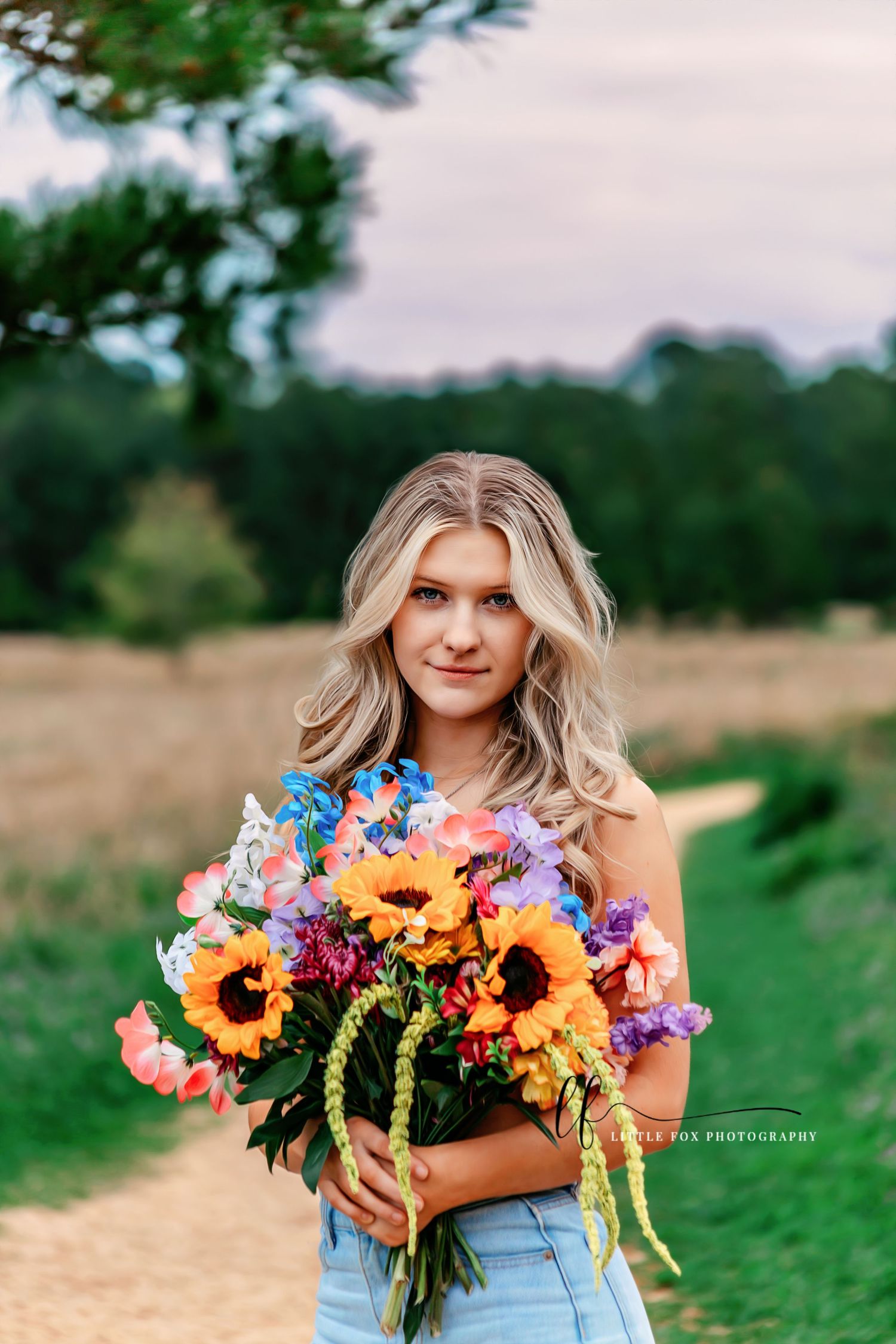 Portrait of senior girl smiling with vibrant flower bouquet