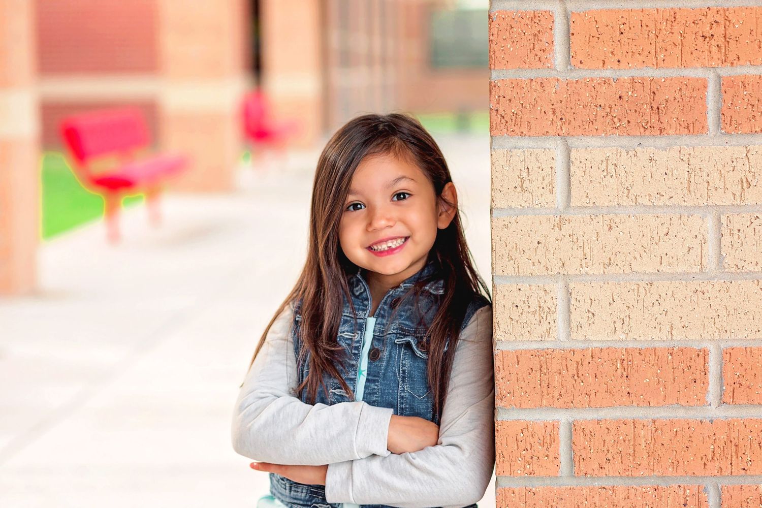 Girl on school grounds smiling for portrait photo