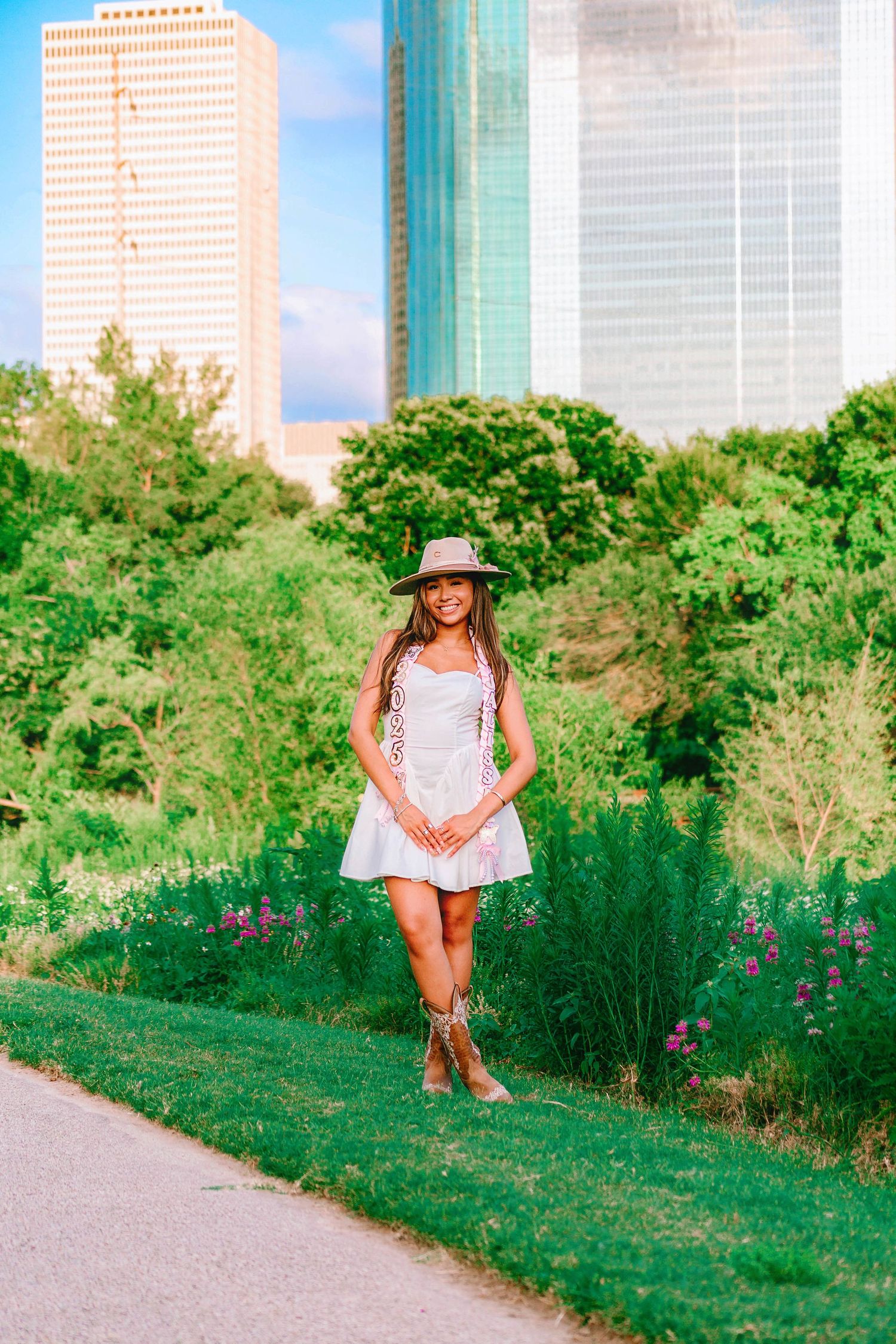 High school senior girl smiling outdoors in casual outfit with natural background