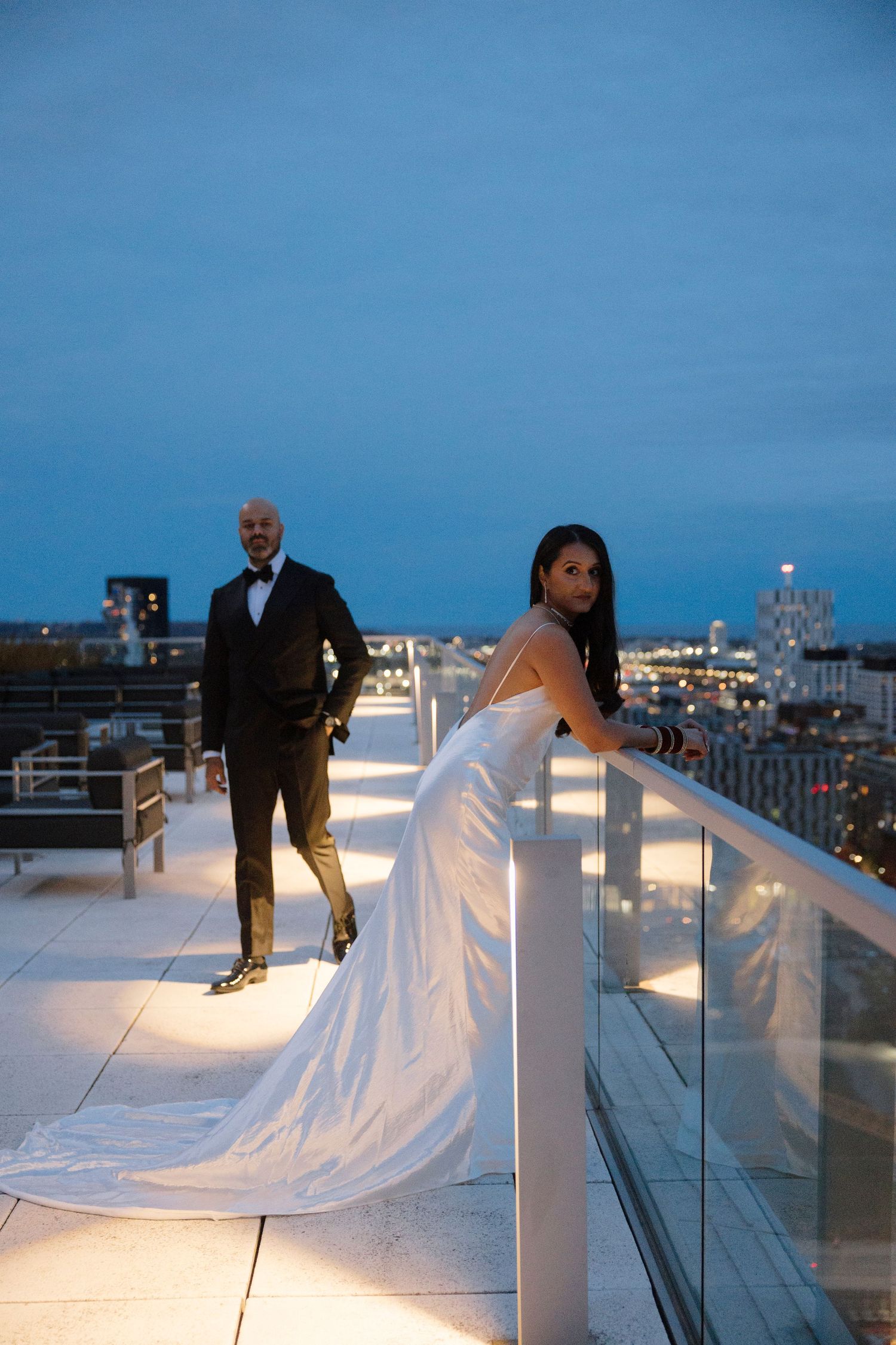 A romantic rooftop wedding photo sequence shows a flowing white dress trailing across an urban skyline at dusk.