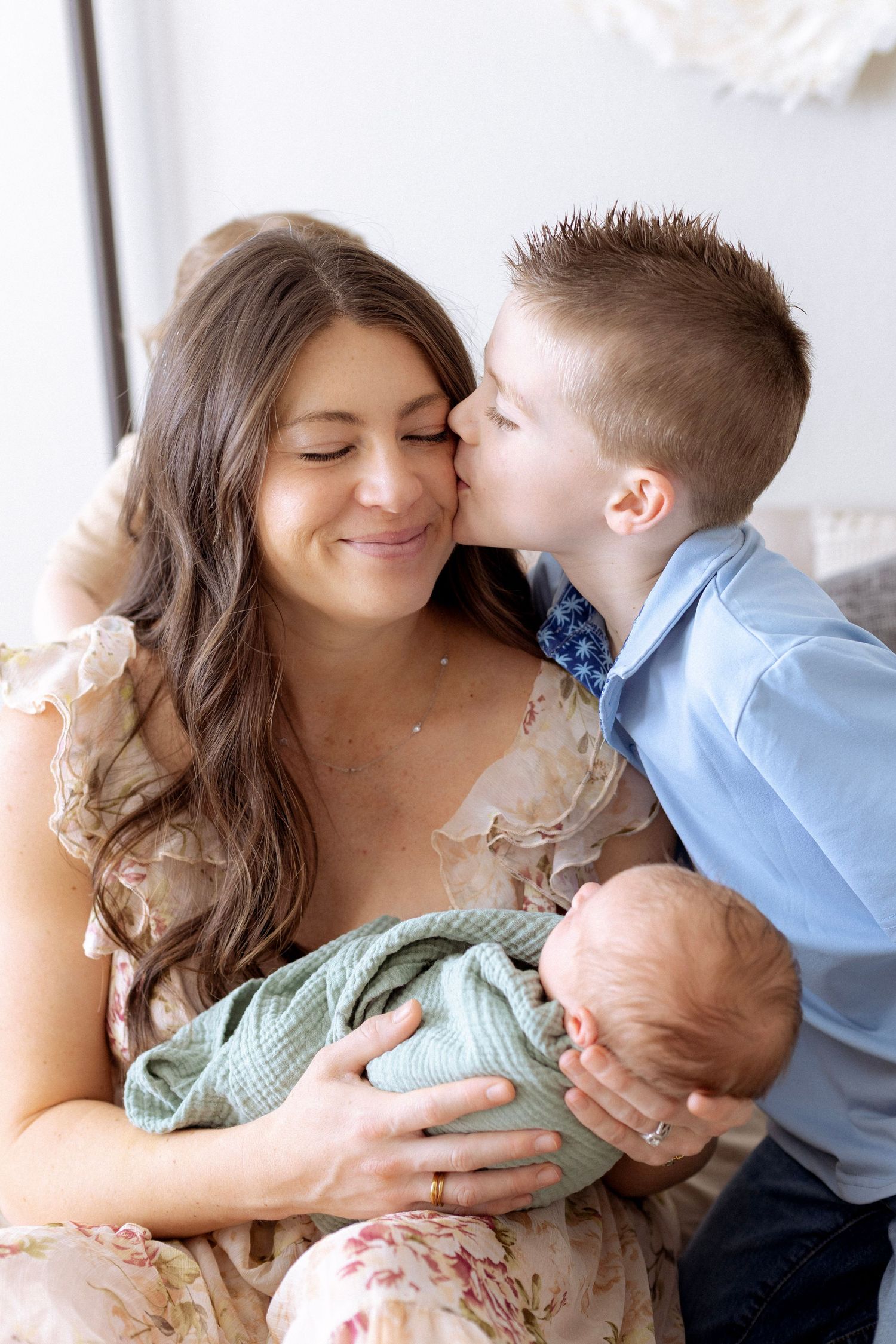 A tender moment captured in a series of four connected photos showing affectionate embraces and kisses.