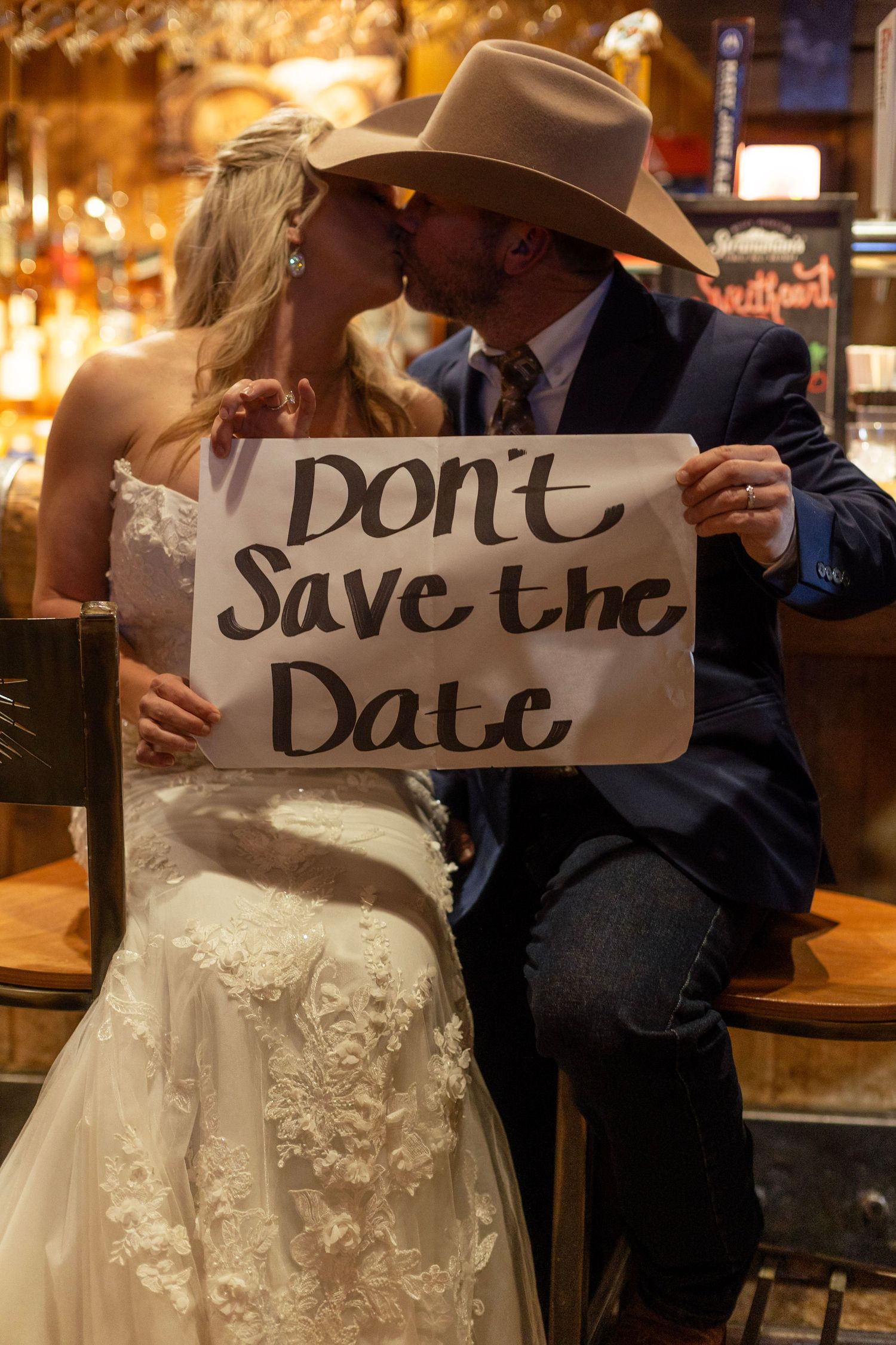 A series of wedding photos showing a couple holding 'Save the Date' signs in a warmly lit indoor setting.