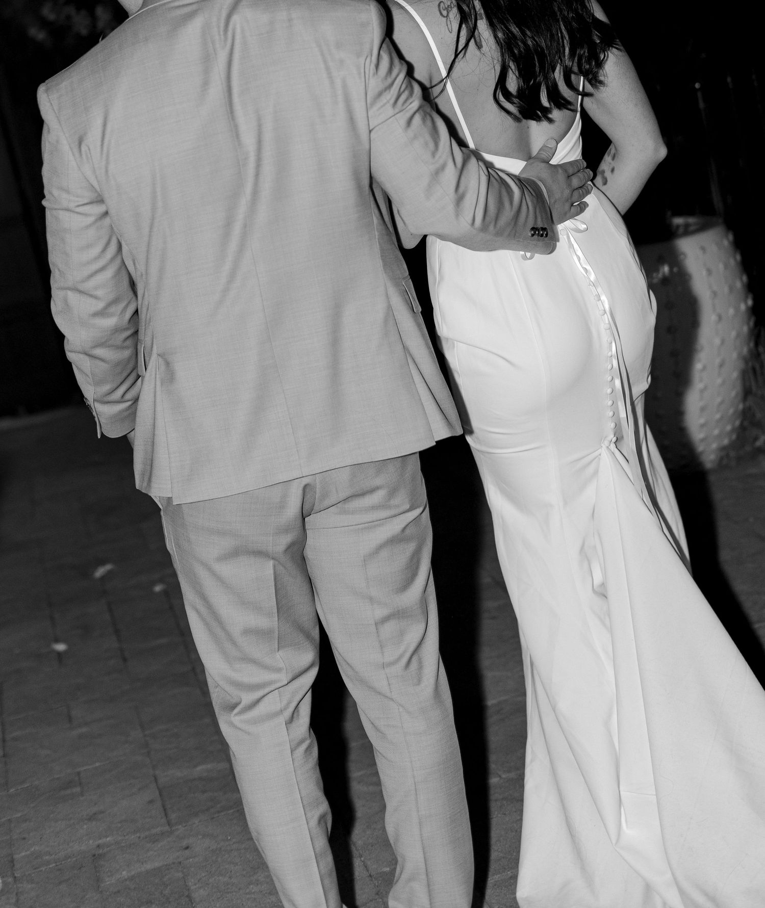 Black and white photo of bride and groom sharing romantic first dance at wedding reception.
