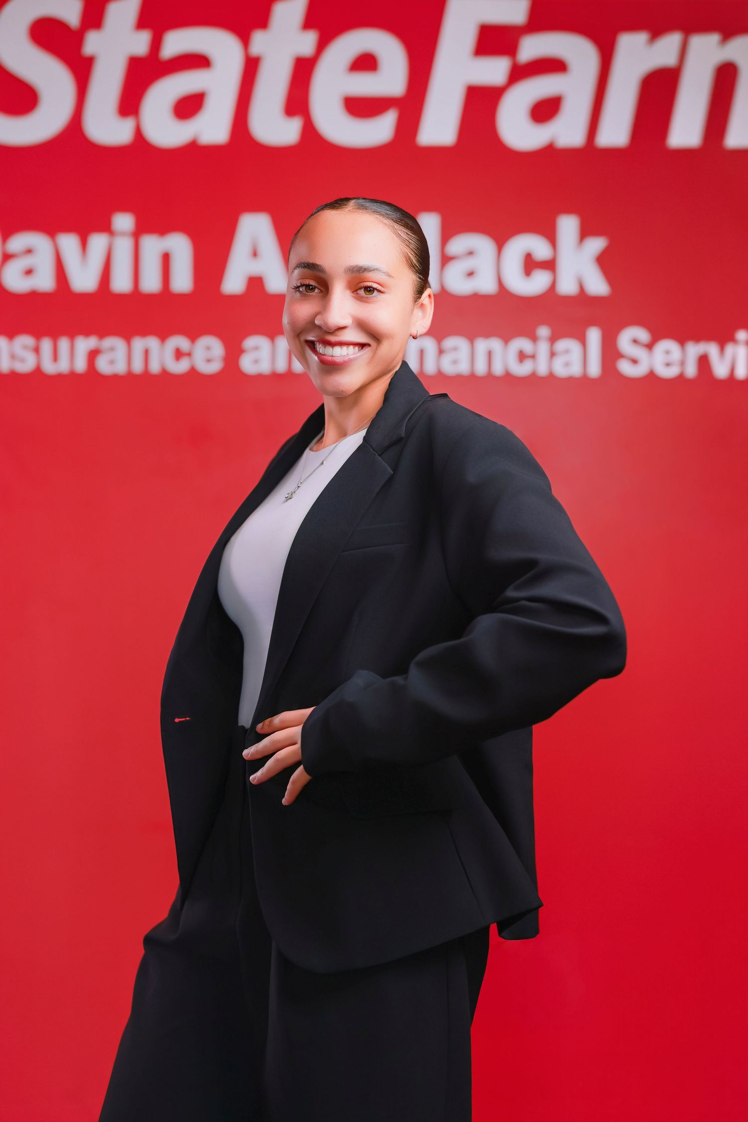 Dynamic poses in black blazer against red State Farm background.