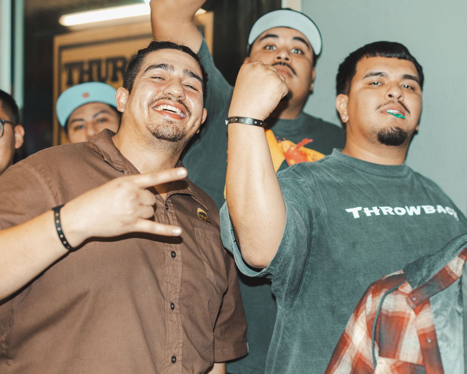 Friends celebrating and posing together after shopping at a sneaker store.