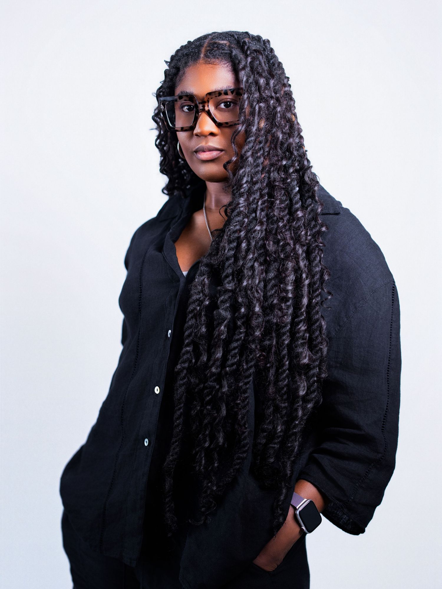 Artistic portrait series showing curly hair and glasses against a white background.