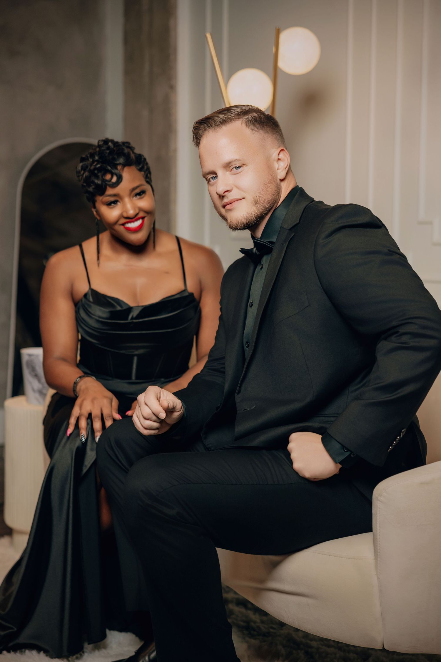 A romantic couple in black formal attire poses intimately together in a series of four connected photos.