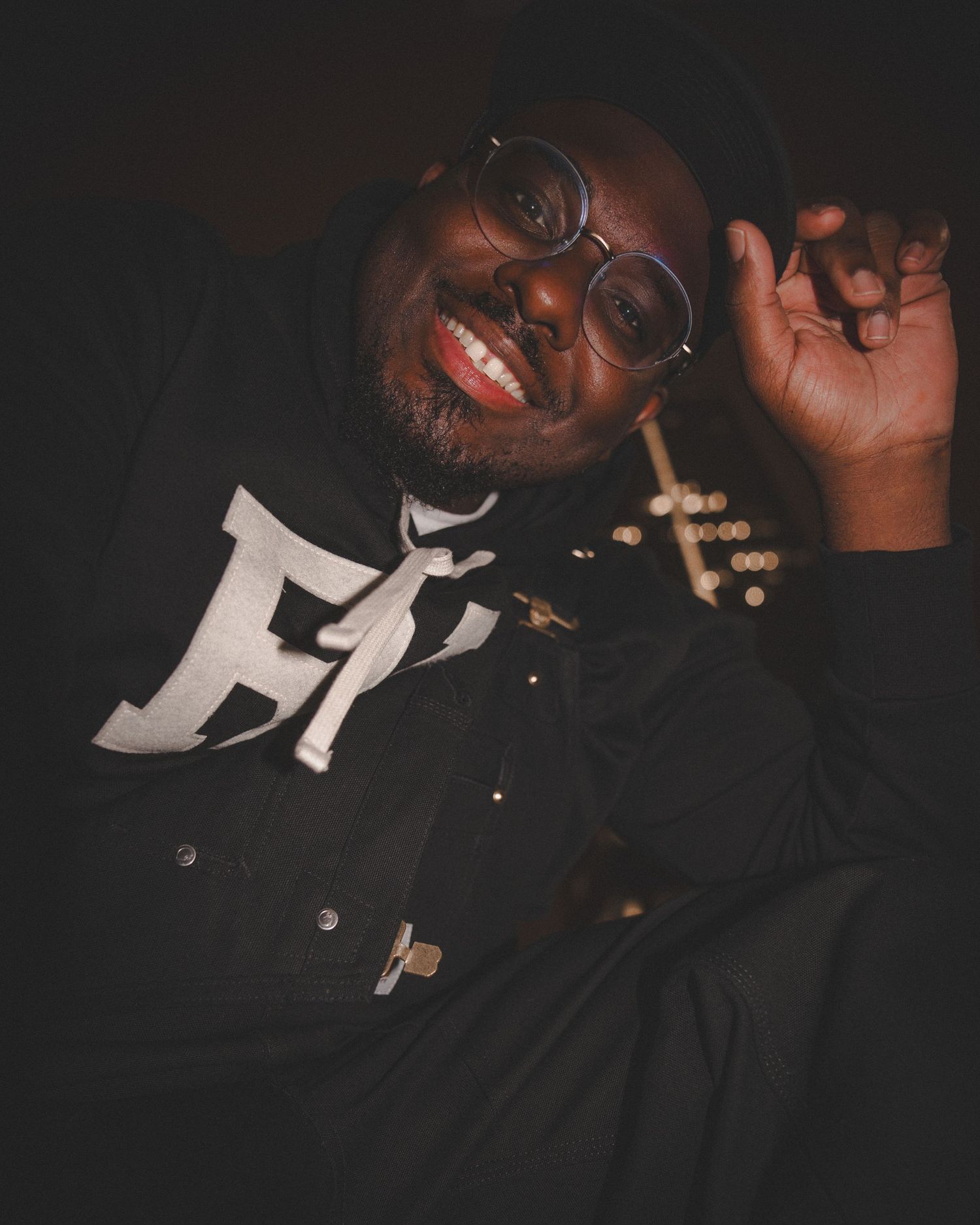 Candid low-light portrait showing laughter and joy in dark setting.