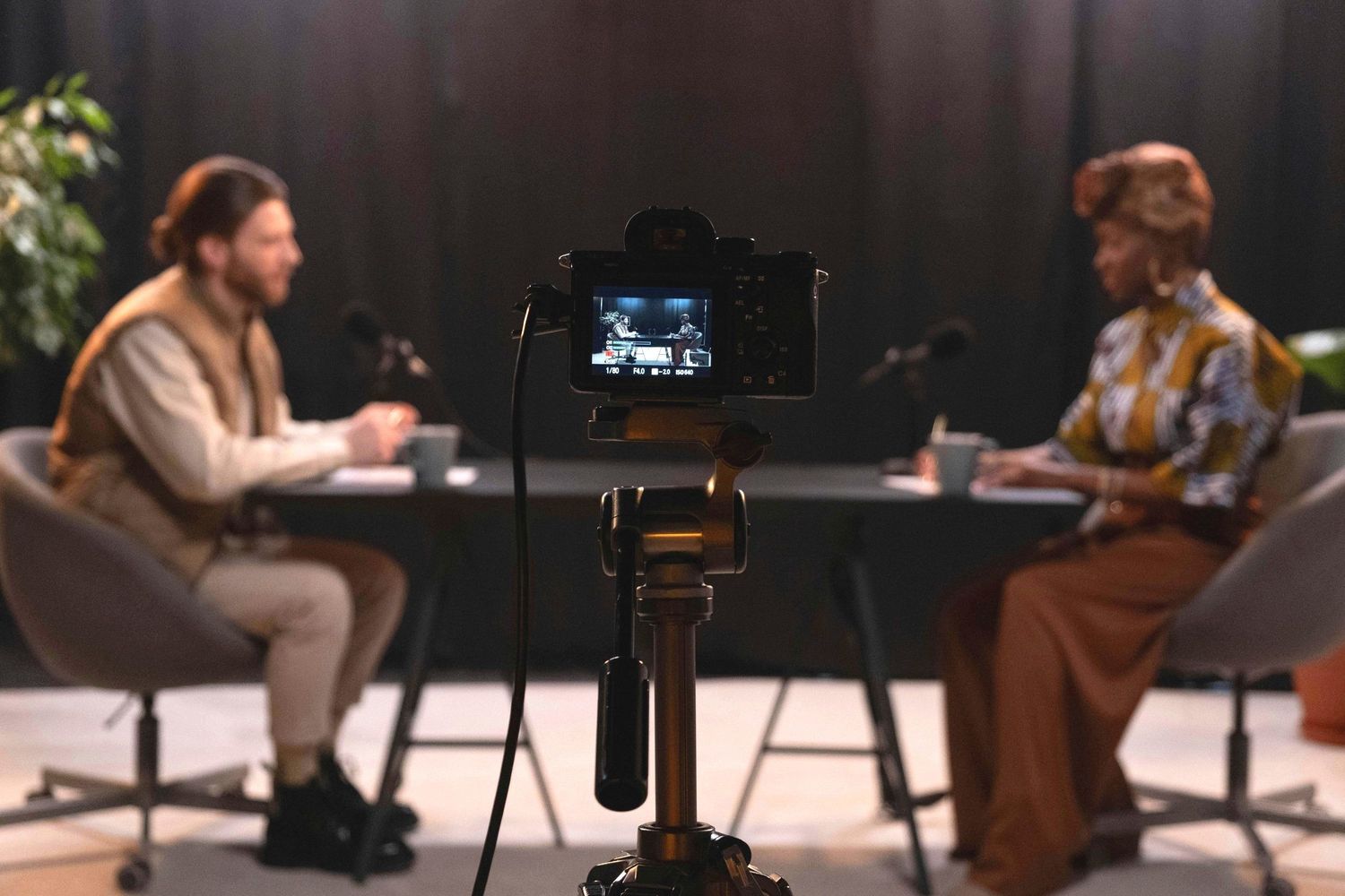 Behind-the-scenes view of a professional video production setup in a dark studio.