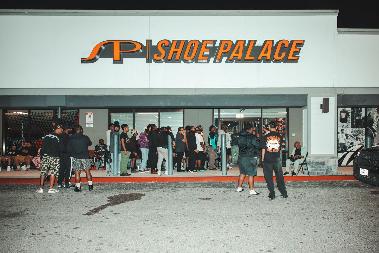 Shoe Palace storefront signage visible in a retail space with people gathered around.